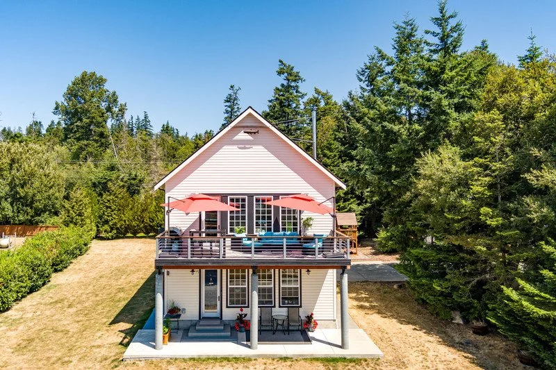 A charming evergreen retreat with bay views from top deck