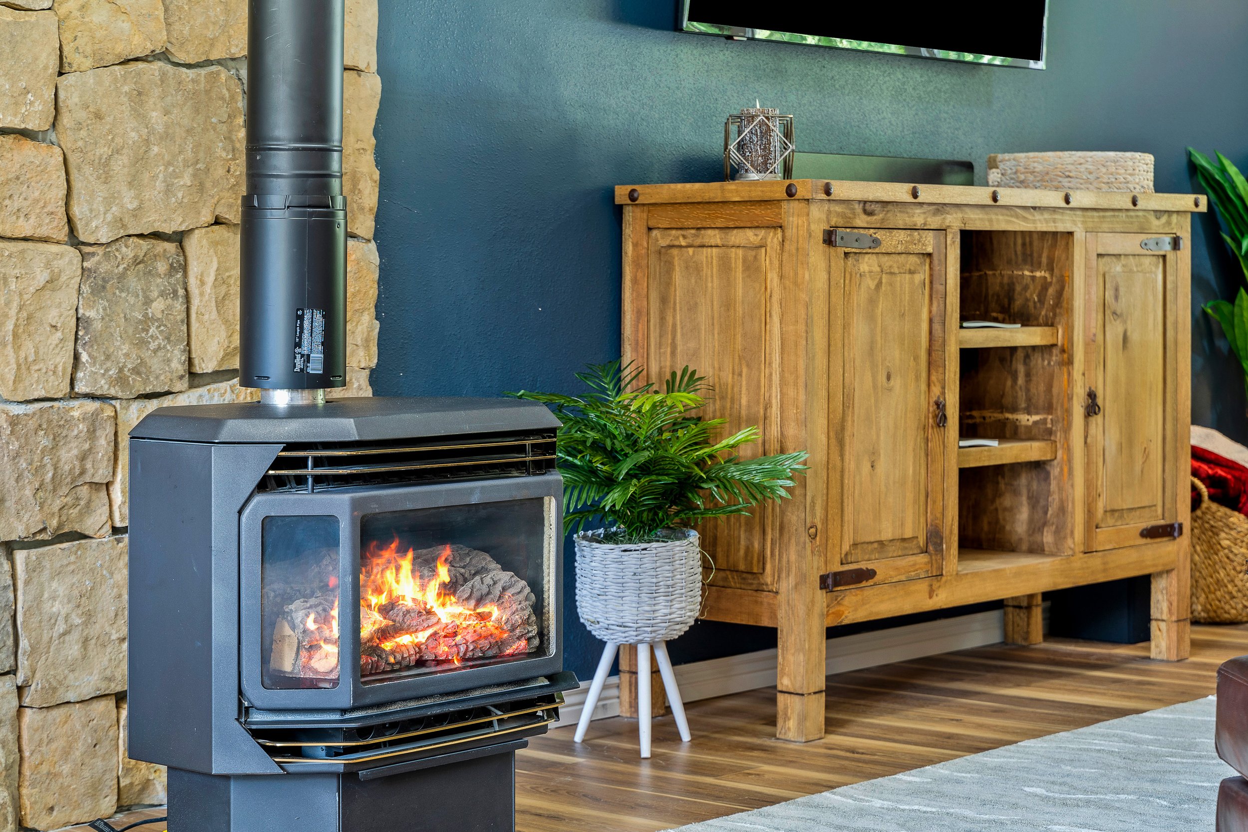 Natural gas fireplace with hand-laid stone surround — the heart of the home on cool Montana evenings