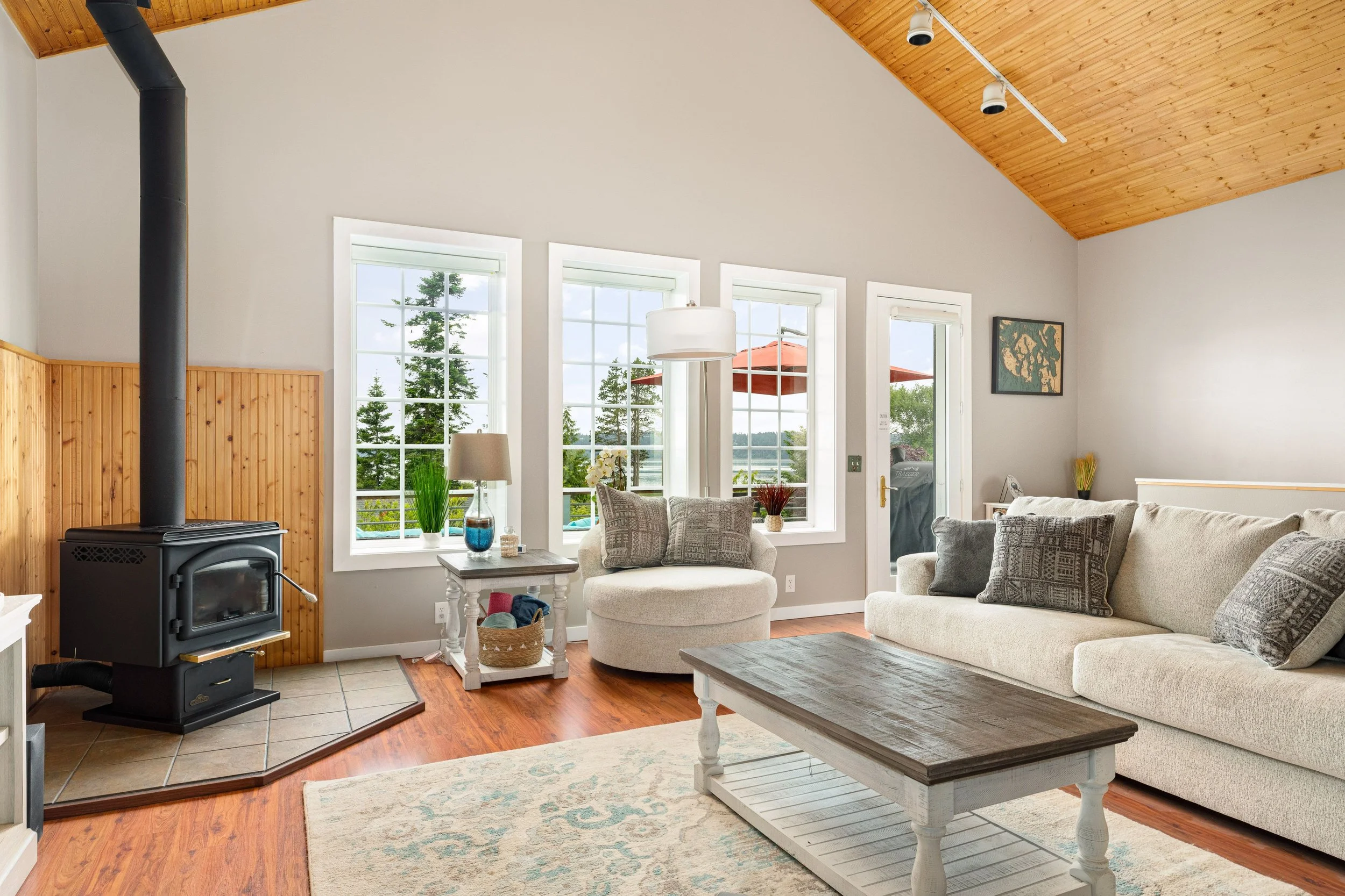 Light-filled living with bay views and deck access.