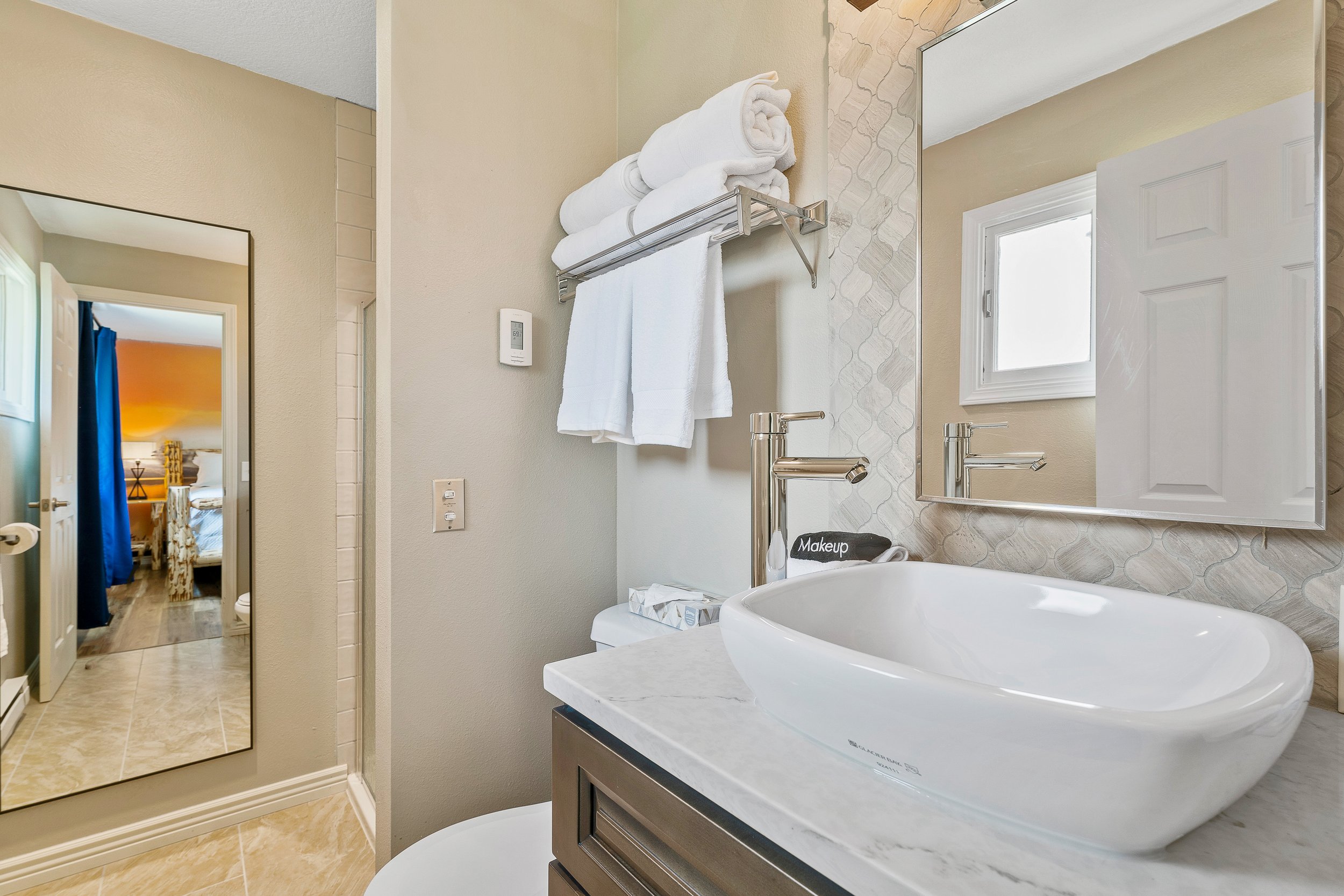Ensuite master bath with vessel sink, quartz counters, and luxe finishes
