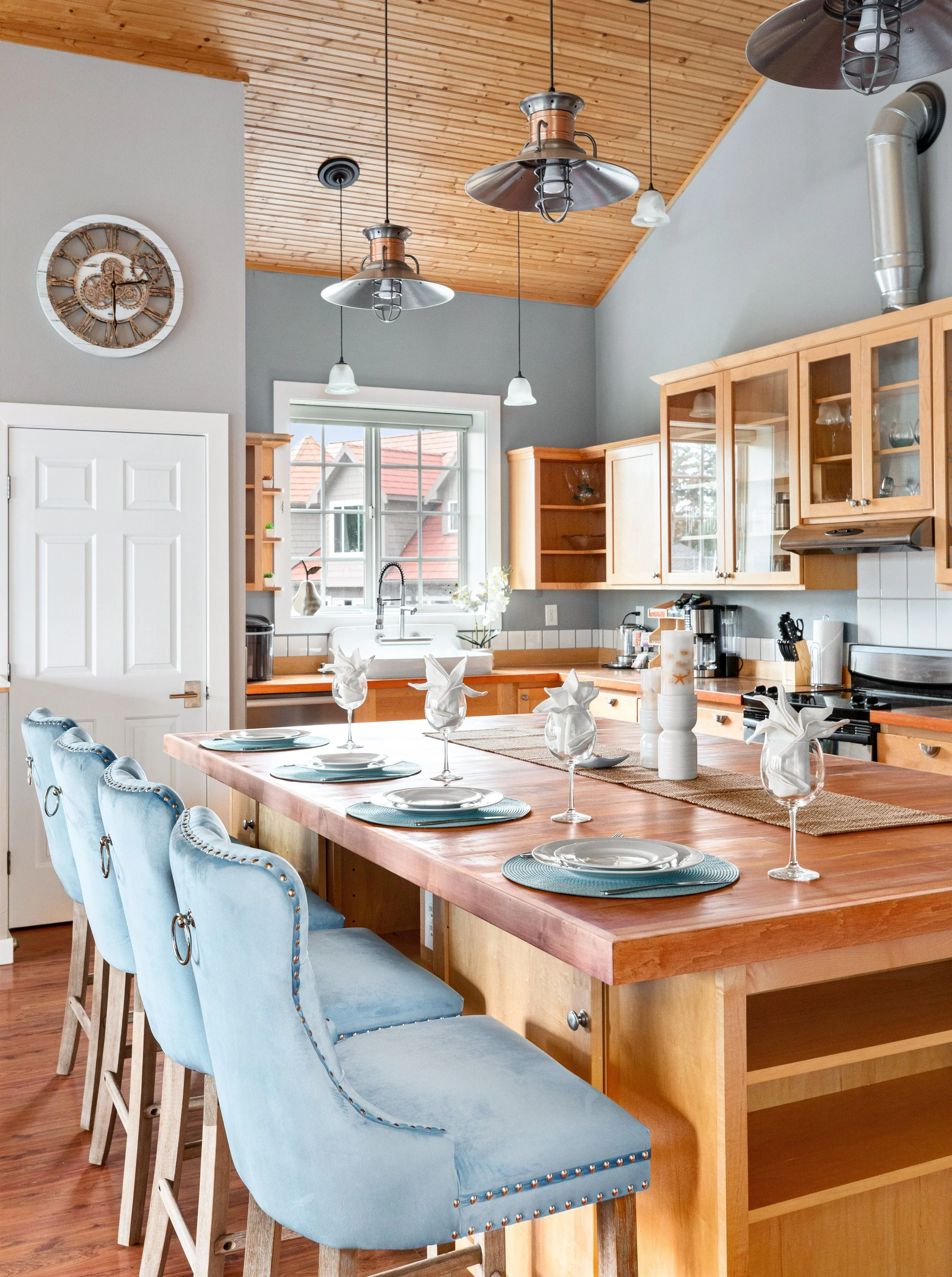 Butcher block island, blue velvet stools, and room to gather.