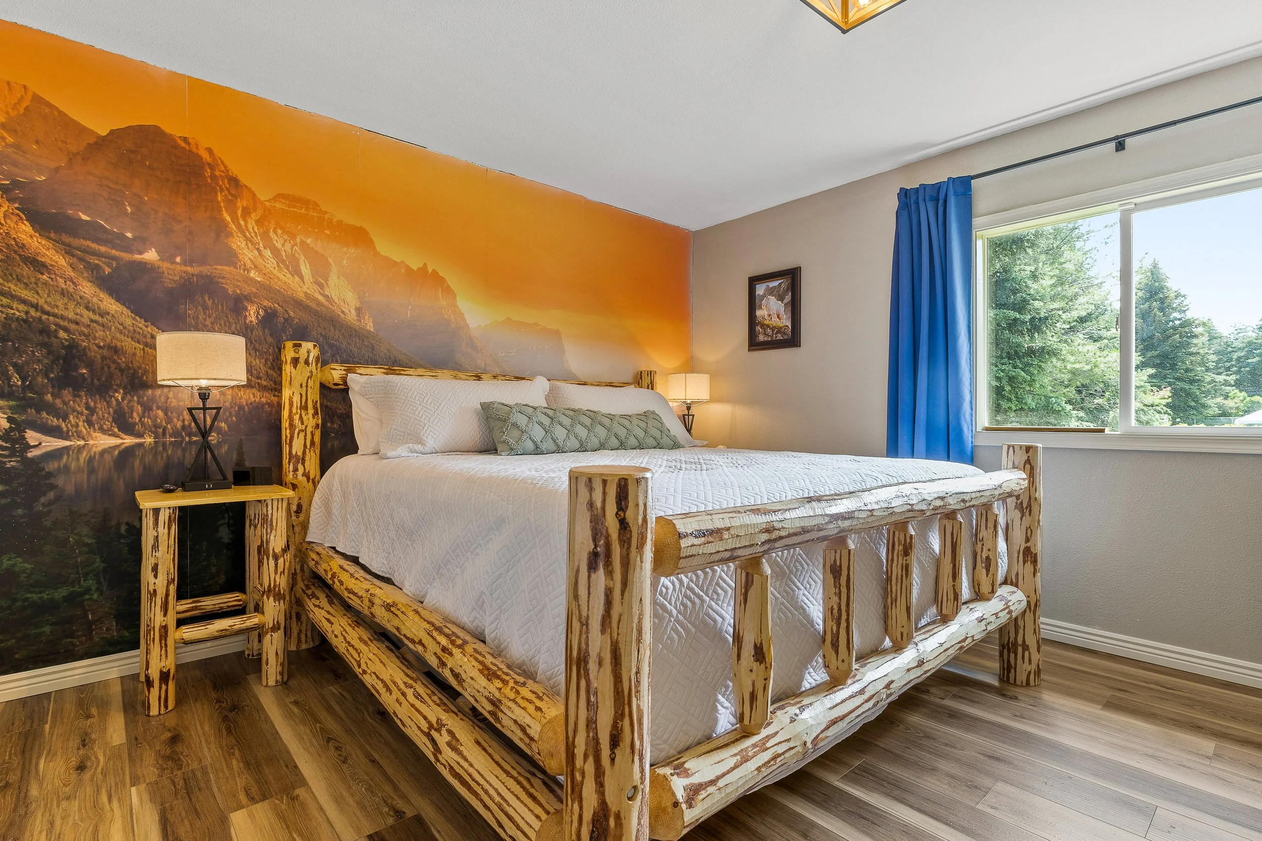 King master suite with handcrafted log bed and dramatic Glacier-inspired mural