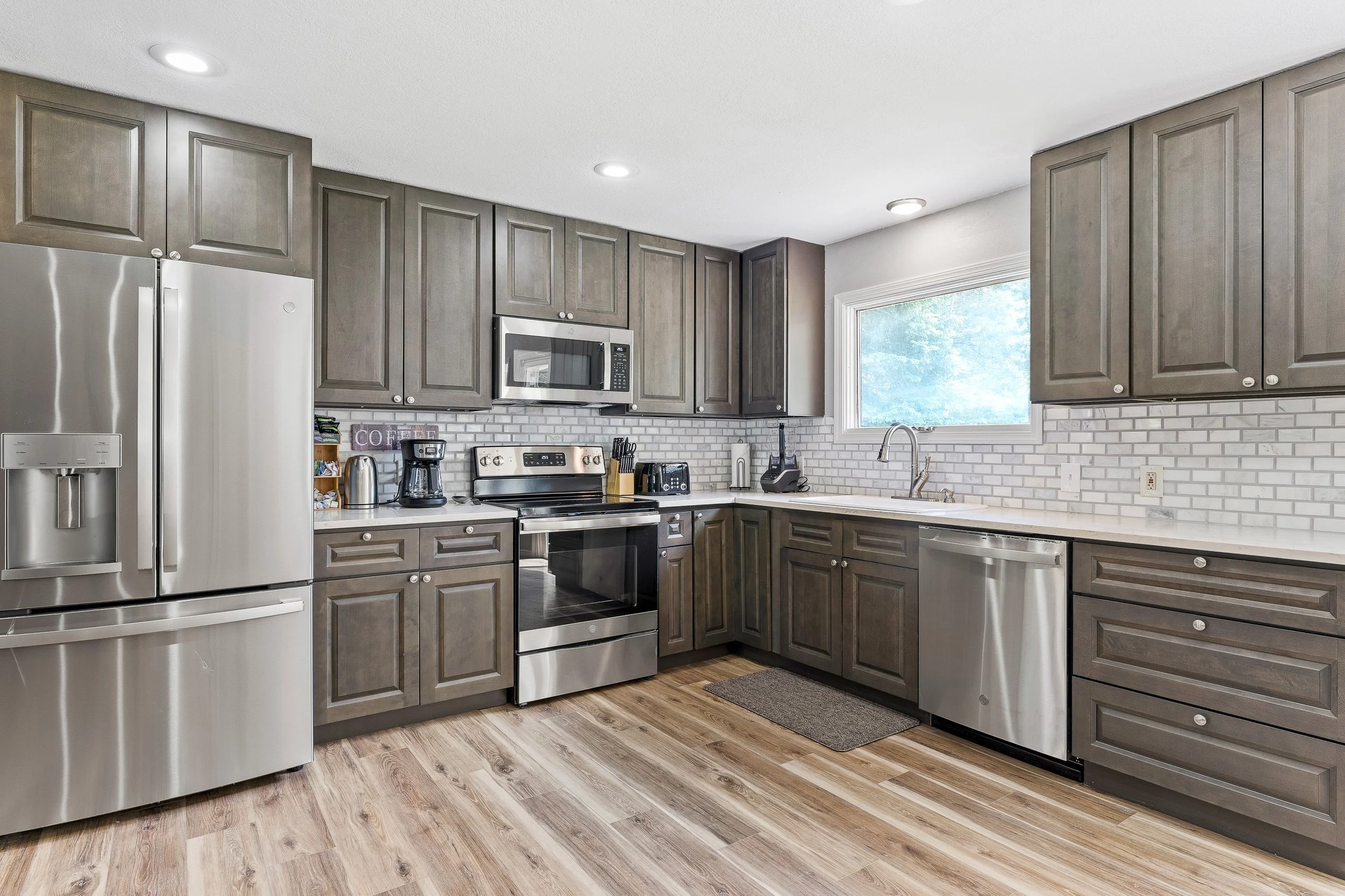 Full residential kitchen with stainless appliances, quartz counters, and everything you need to cook a real meal