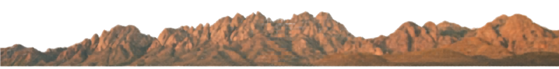 A line of rugged, rocky mountains under a black sky.