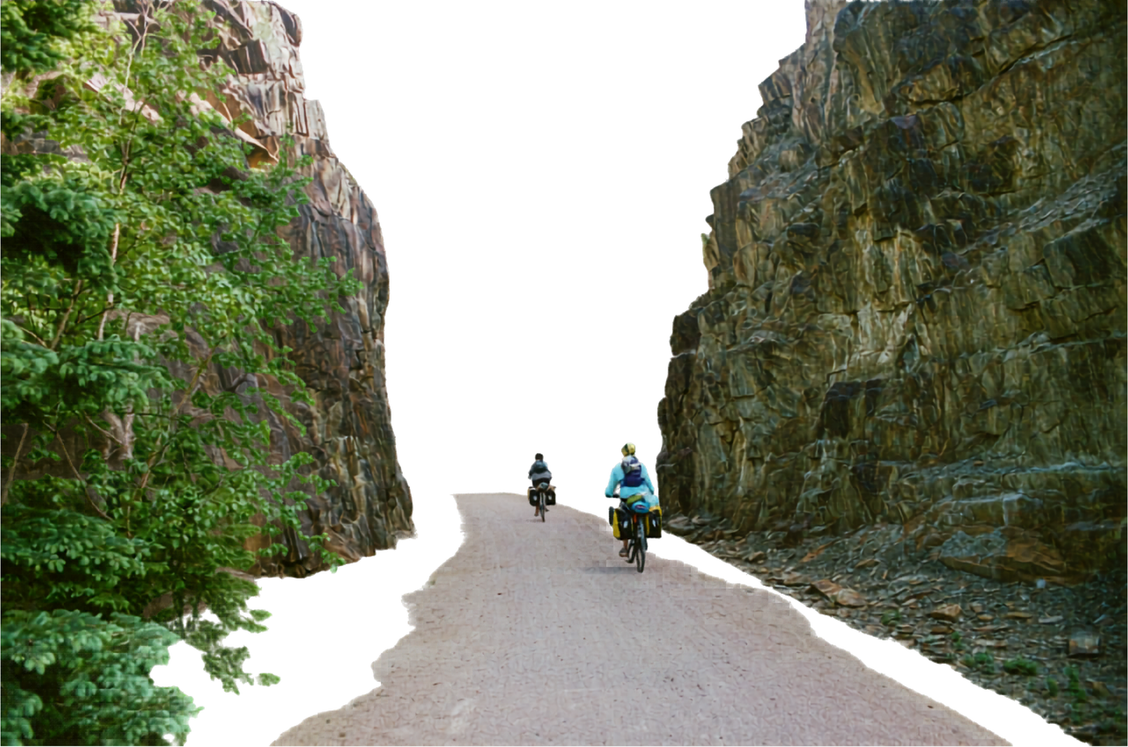 Two people riding bicycles on a dirt trail between tall, rocky cliffs with green foliage.