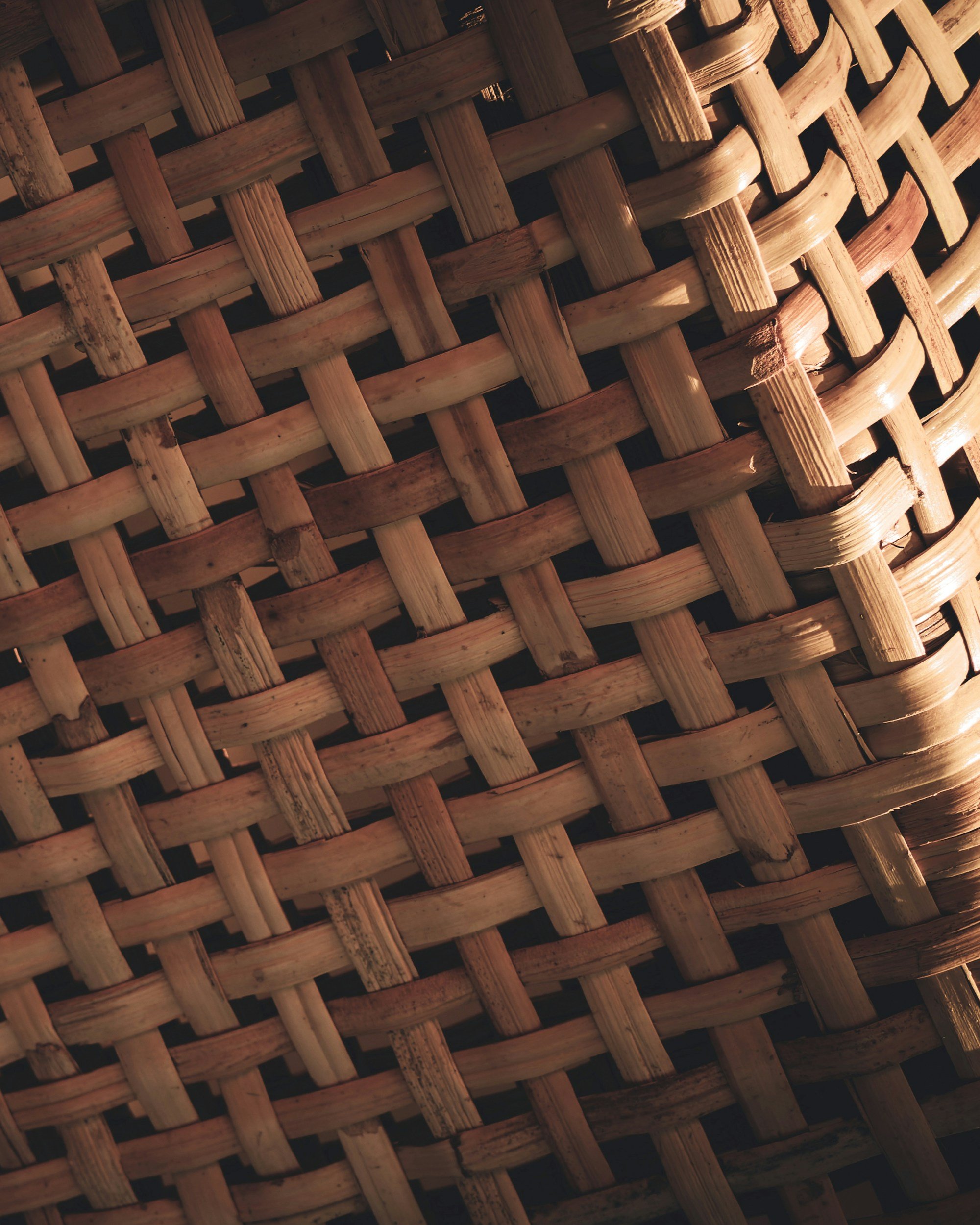 Close-up of a woven bamboo basket with a detailed view of the interlaced pattern of the bamboo strips.