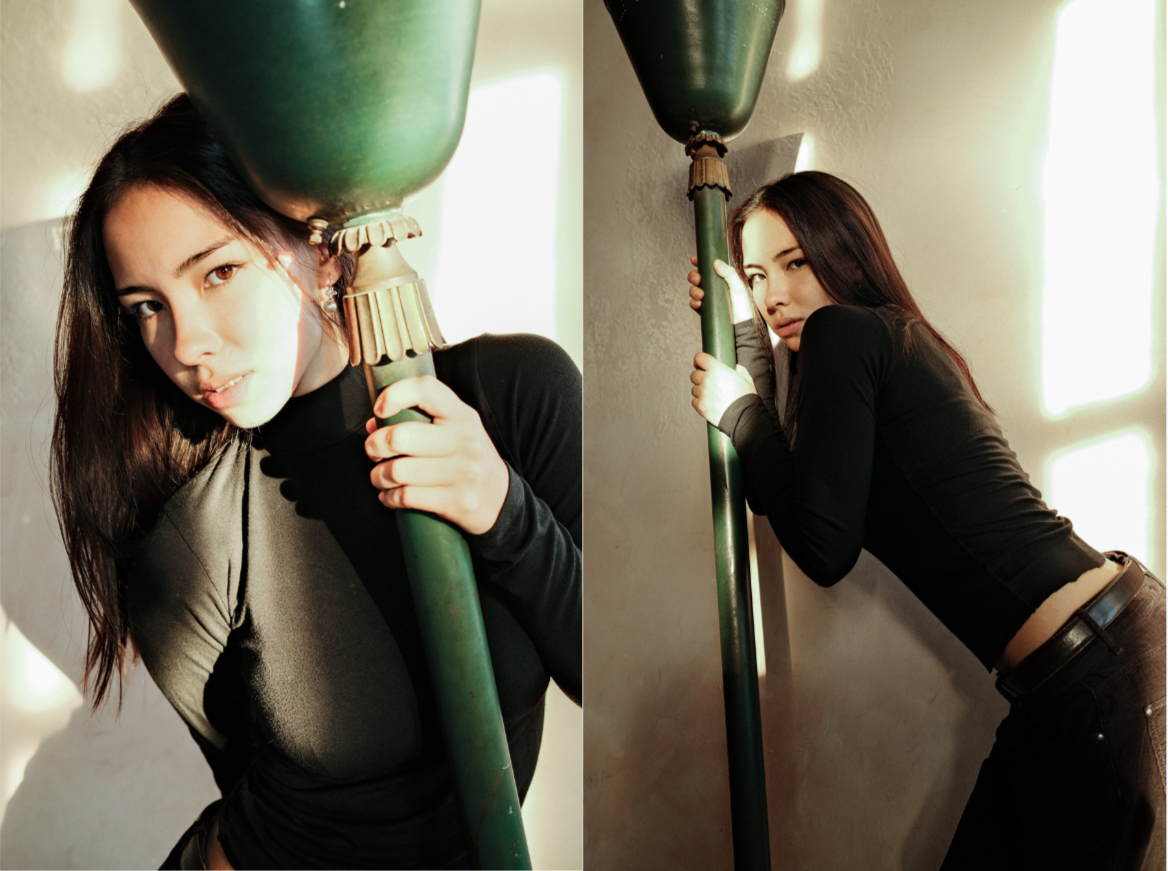 Side-by-side photos of a woman with dark hair holding a green pole, leaning against a wall. She wears a black long-sleeve shirt in both images, with a serious expression in the first and a slightly playful expression in the second. Soft lighting crea