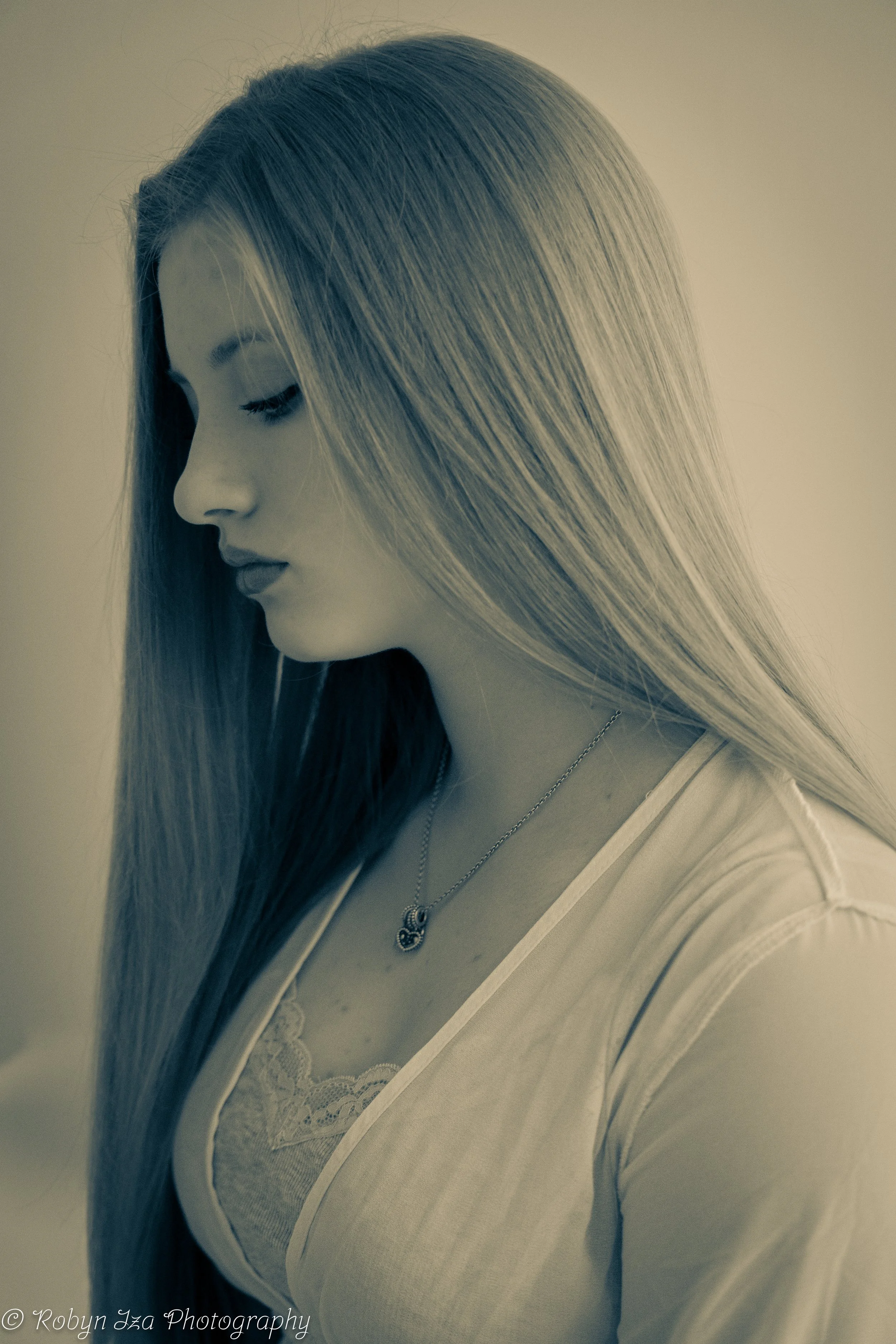 profile of a girl with long blonde hair looking down