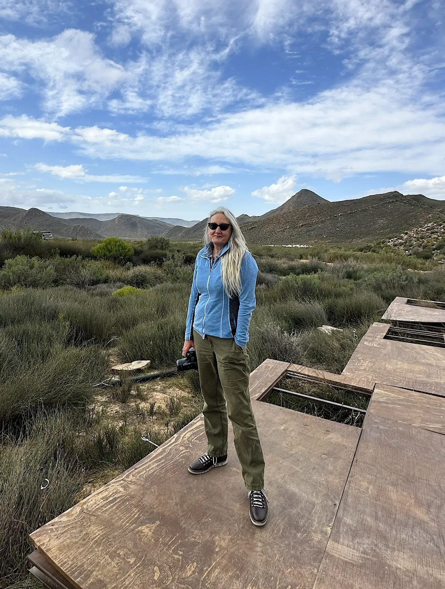 Jamie K. Reaser standing in a South African landscape