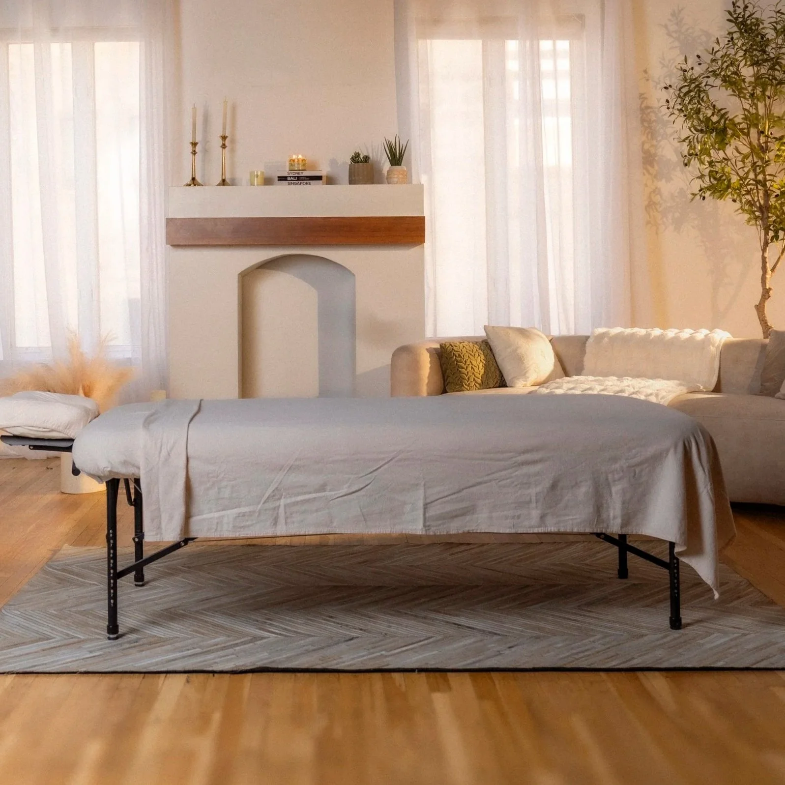 Massage table: "Massage table set up with linens in living room, prepared for a session