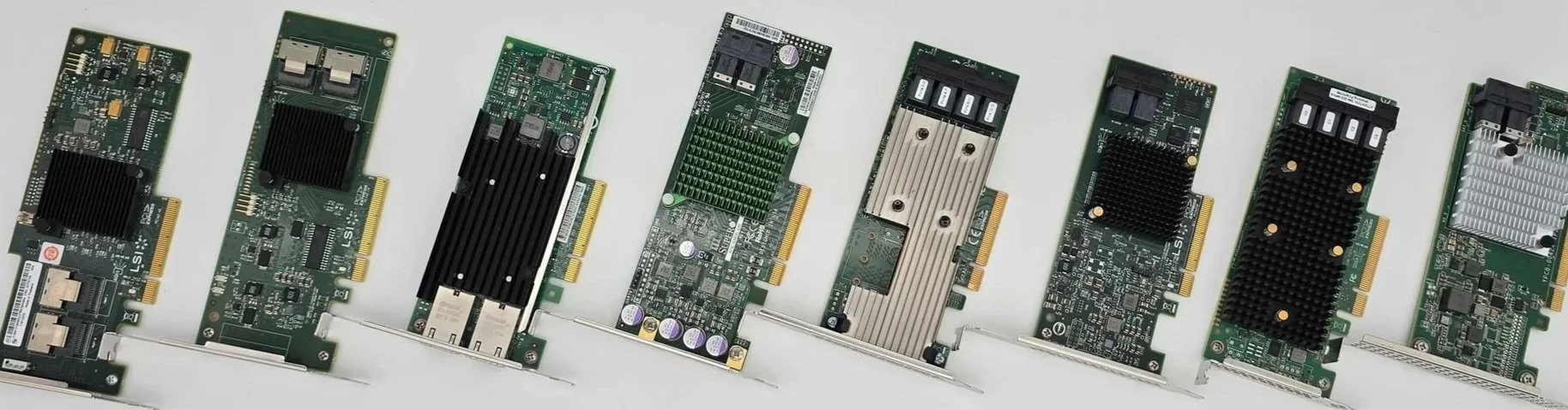 Collection of various computer graphics cards arranged in a row on a white background.