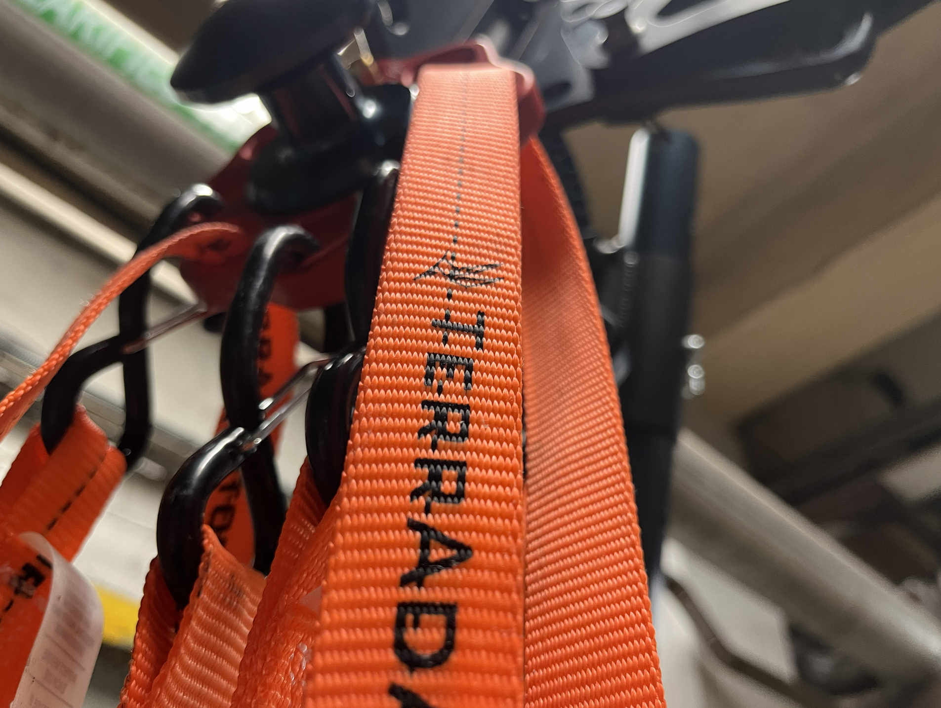 Close-up of an orange strap with black text that says Terradaptor, an advanced Tripod system for Confined Space Rescue and High Angle Rescue services.