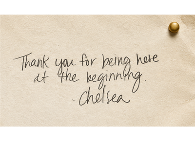 A handwritten note on beige paper that says, "Thank you for being here at the beginning. -chelsea" with a gold thumbtack in the top right corner.
