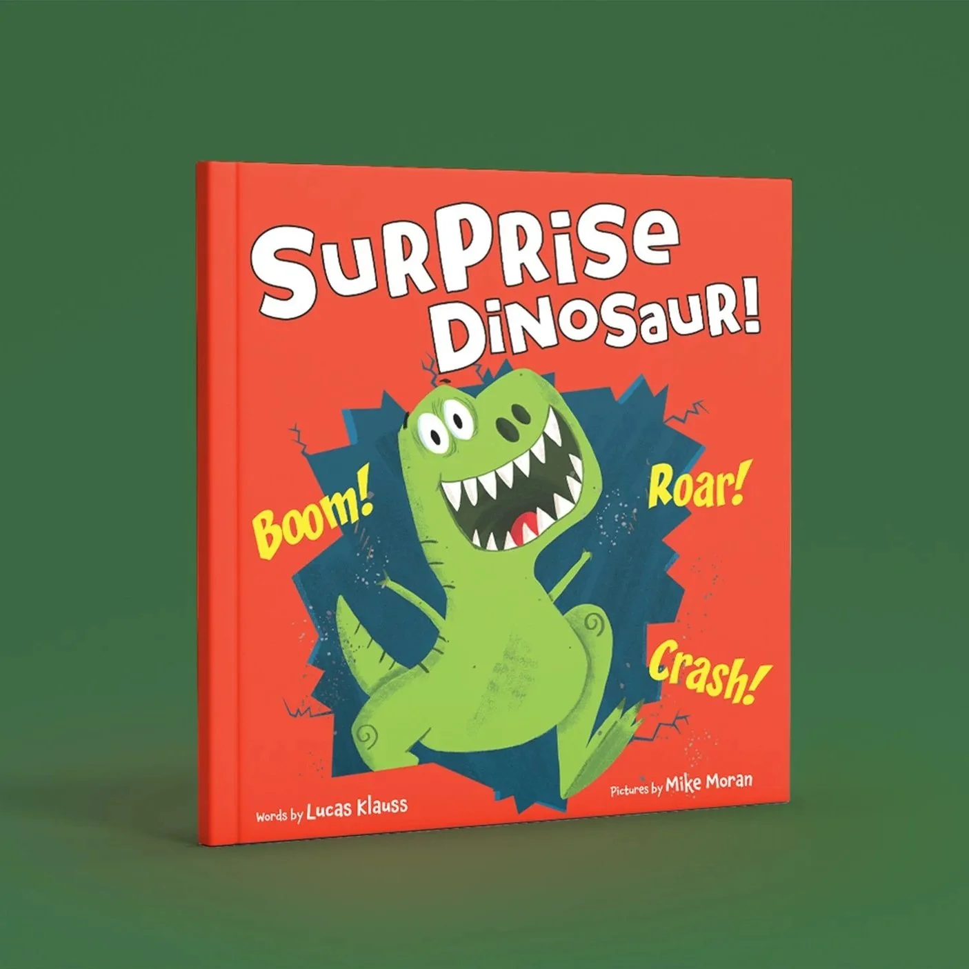 Children's book titled "Surprise Dinosaur!" with a cartoon green dinosaur on the cover, roars with open mouth, showing sharp teeth, with words "Boom!", "Roar!", and "Crash!" around it, Words by Lucas Klauss. Pictures by Mike Moran.
