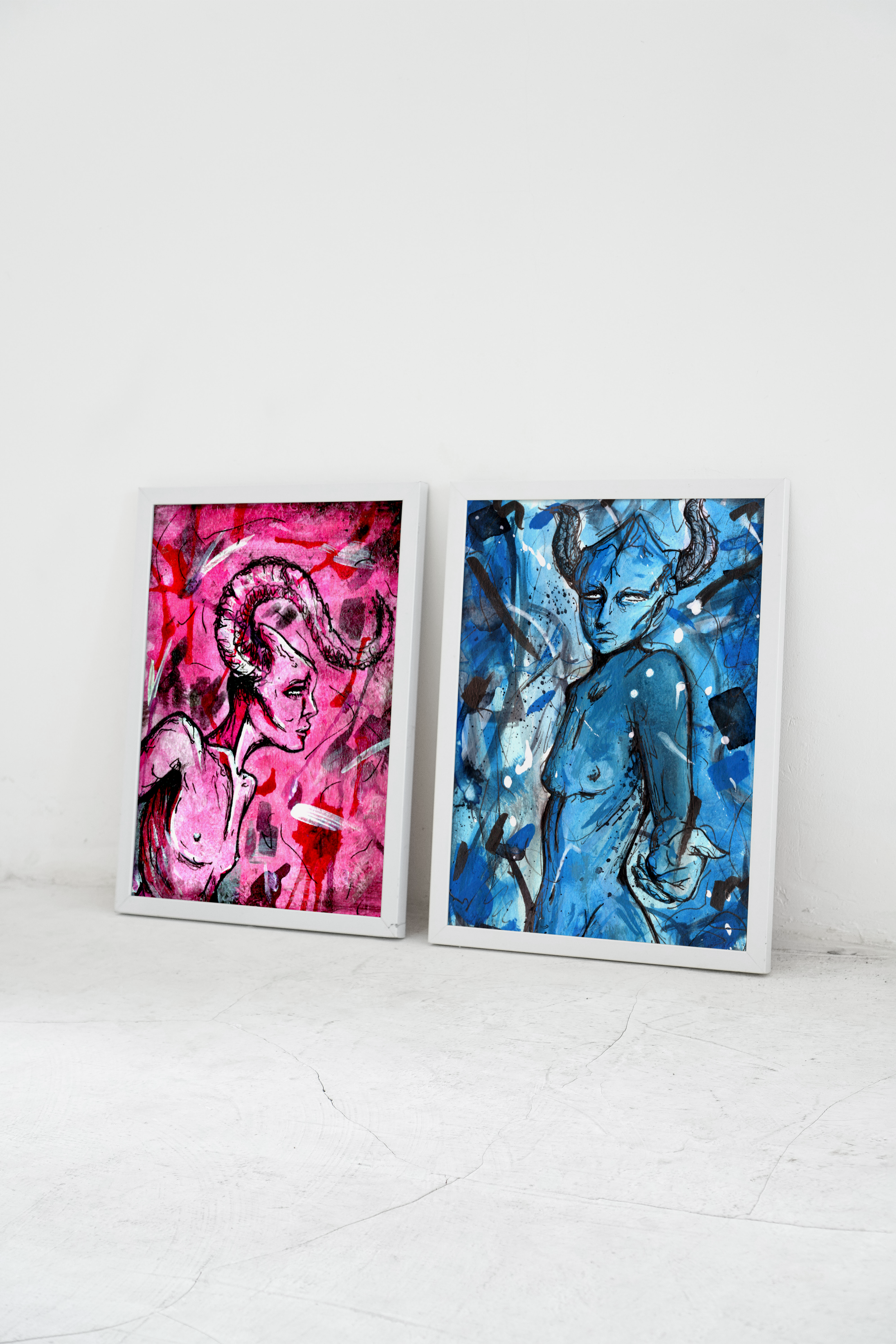 Two framed abstract paintings of female figures leaning against a white gallery wall with shadow and reflections on the frames.