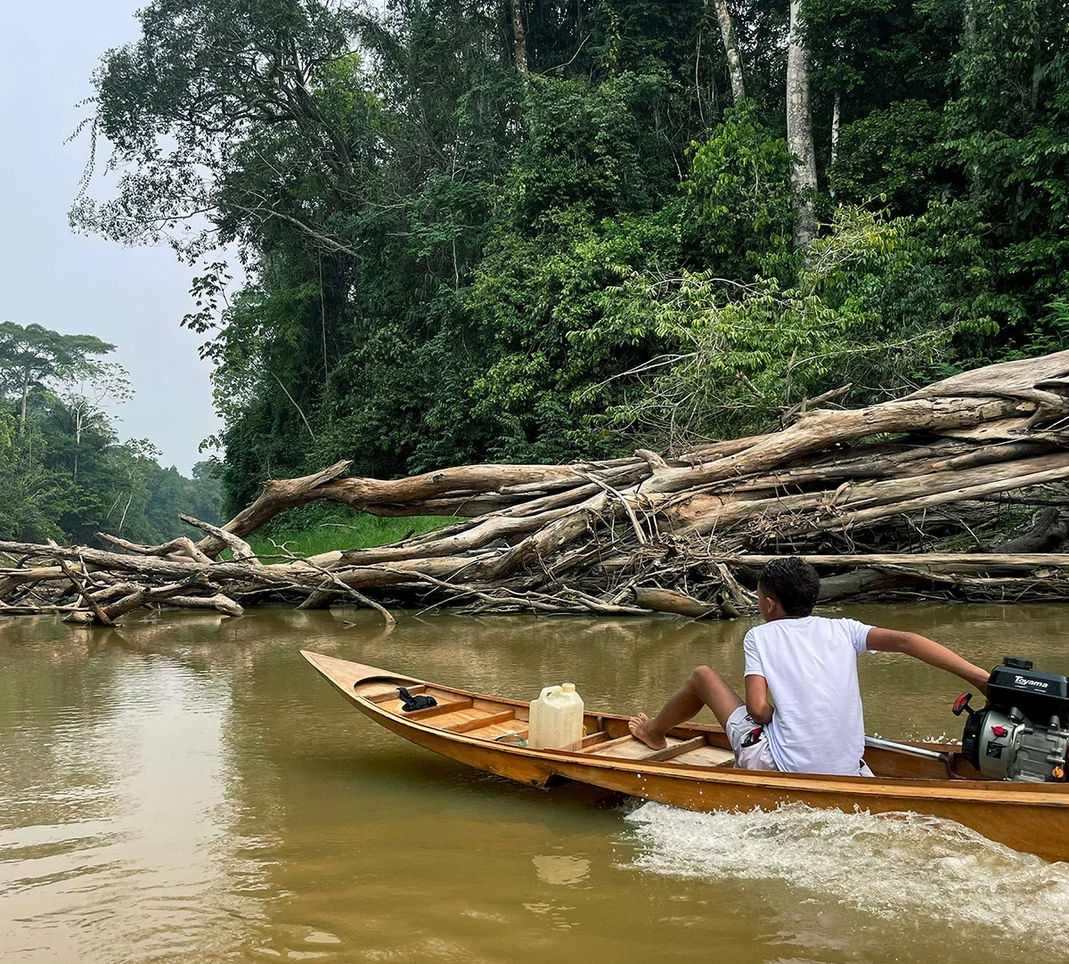 Young resident travelling by canoe in a remote Amazon community