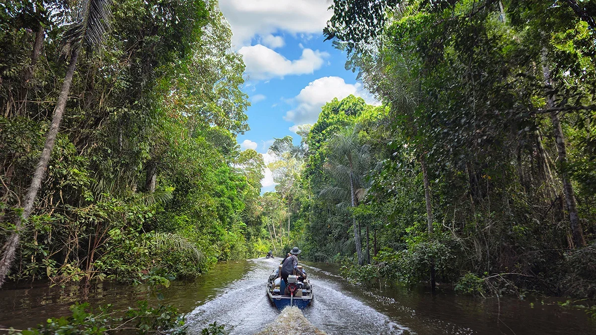 Small boat travelling along the Boa Fé River in the Brazilian Amazon
