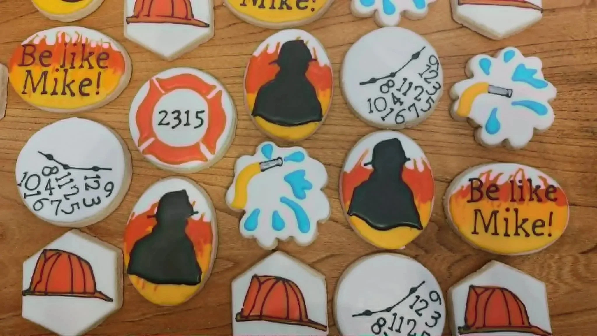A collection of decorated cookies with a firefighter retirement theme