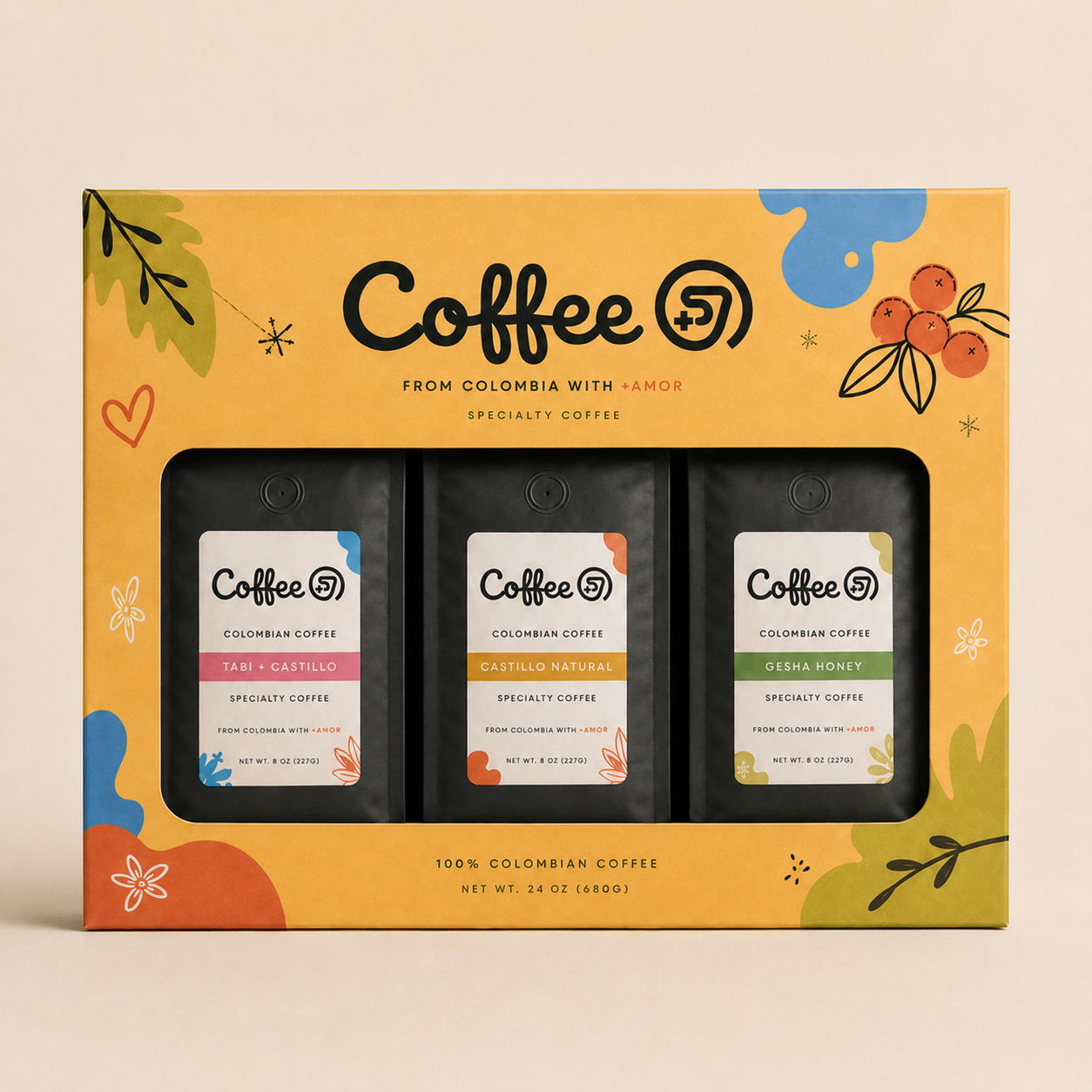 A colorful box of Colombian specialty coffee with three different flavors: Tabi + Castillo, Castillo Natural, and Gesha Honey. The box is decorated with abstract floral and leaf patterns.