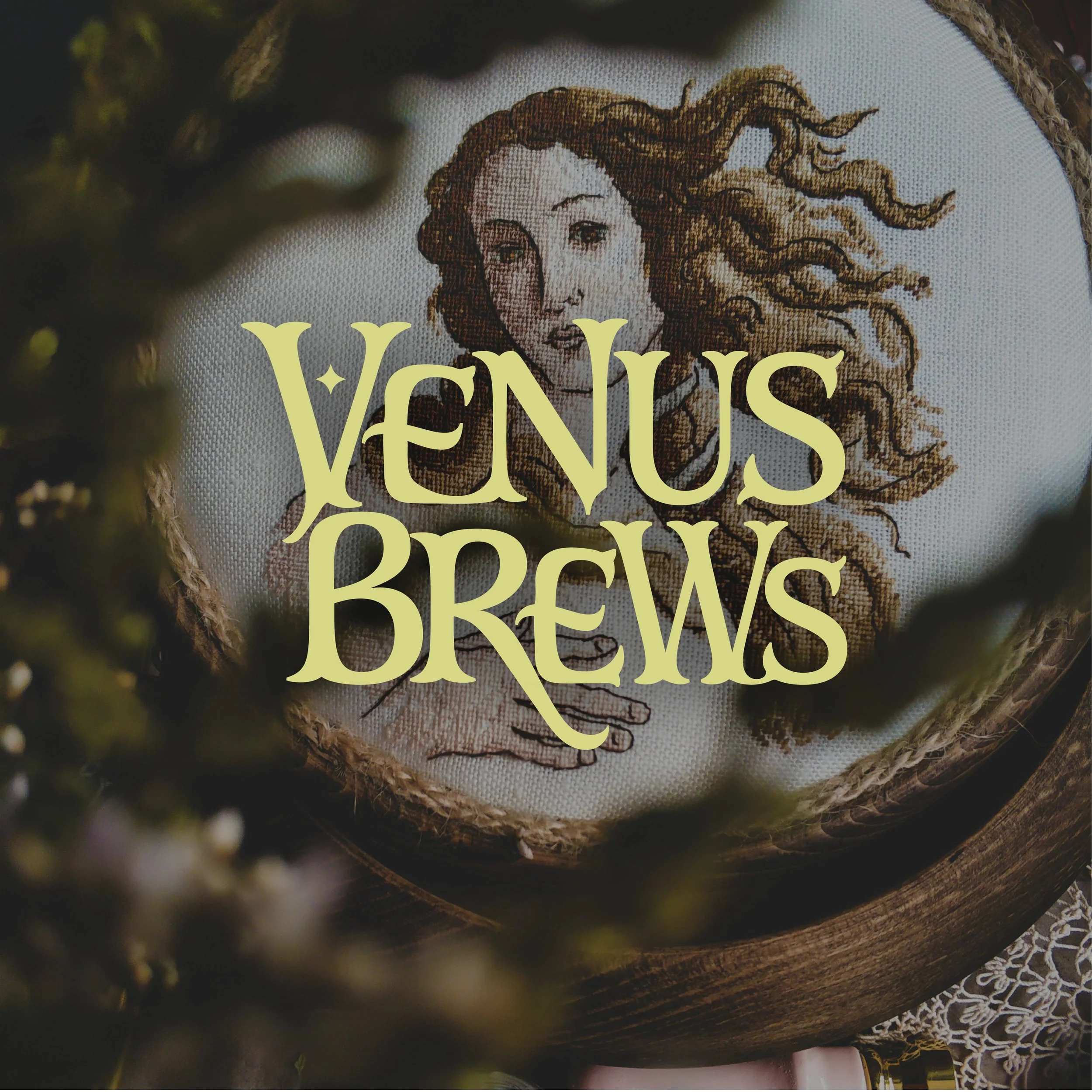 Close-up of embroidery featuring a woman's face with flowing hair and the text 'Vans' in large yellow letters, surrounded by a rustic, textured background.