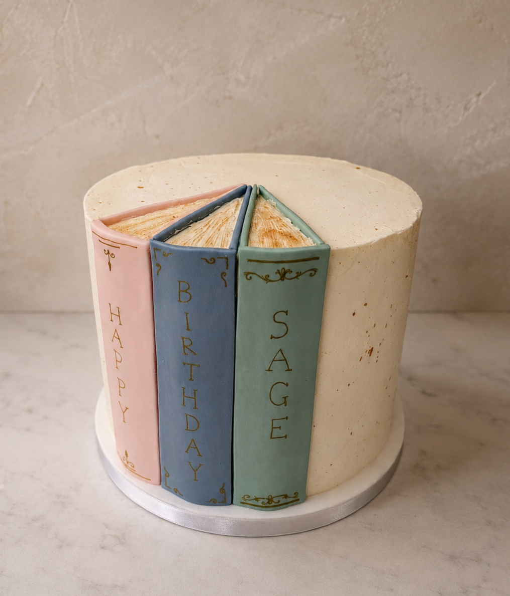 Fondant book spines and gold spattered buttercream