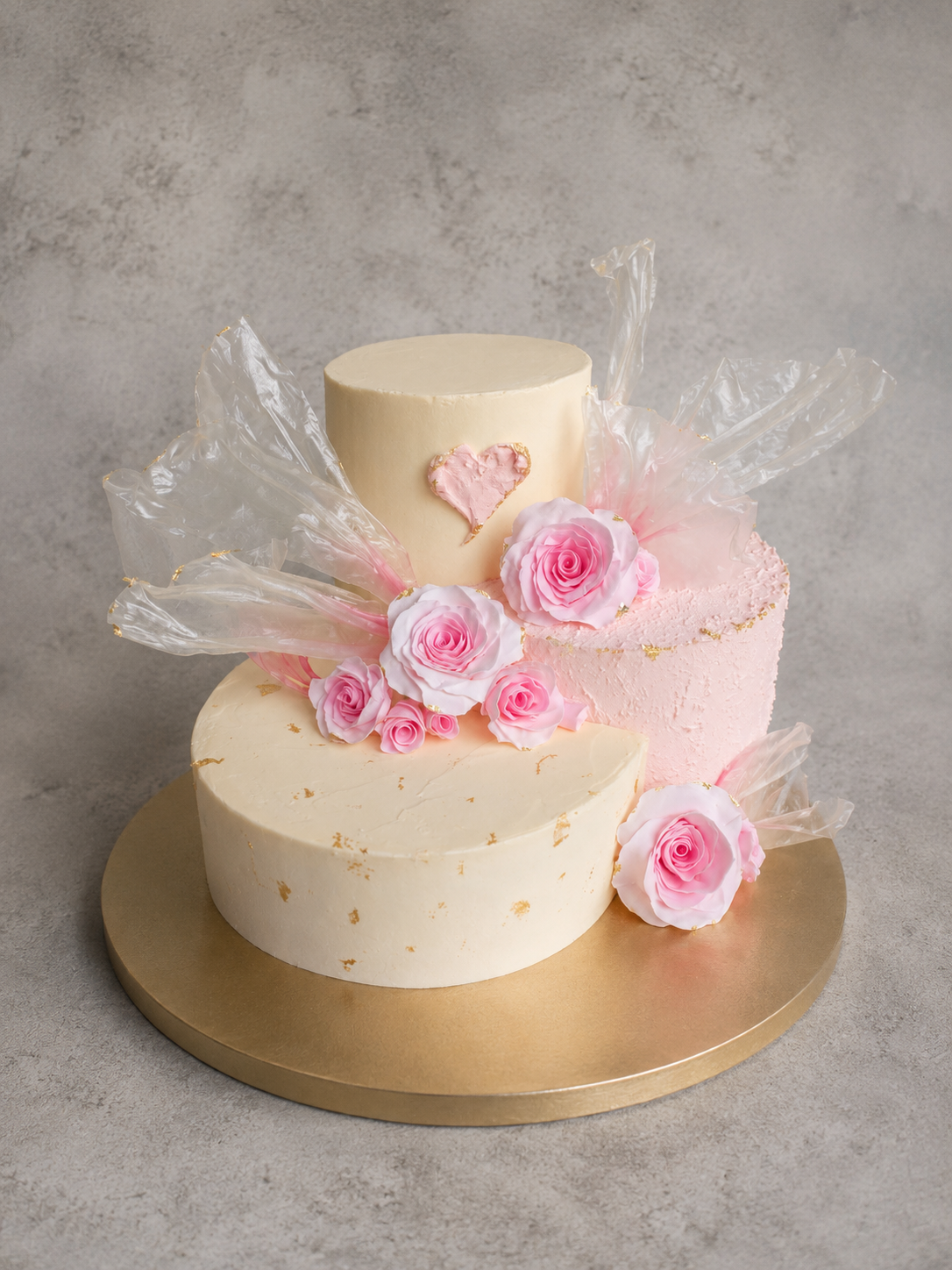Side-by-side tiered cake with handmade sugar roses and rice paper sails