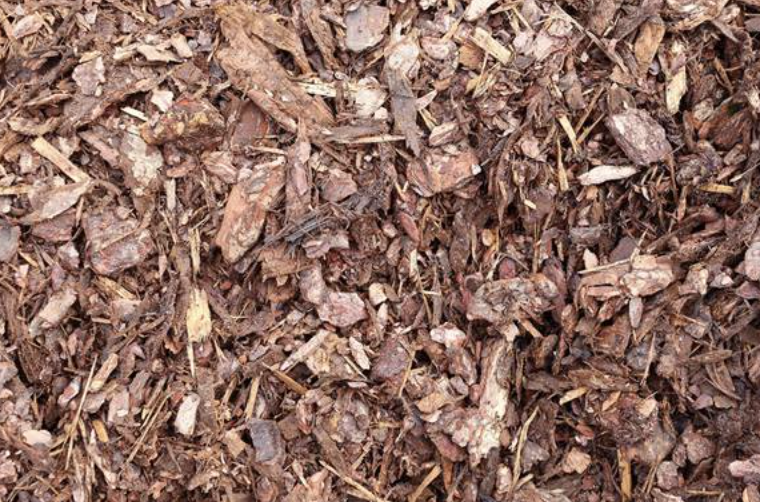 Close-up of wood mulch composed of shredded bark and small wood chips.