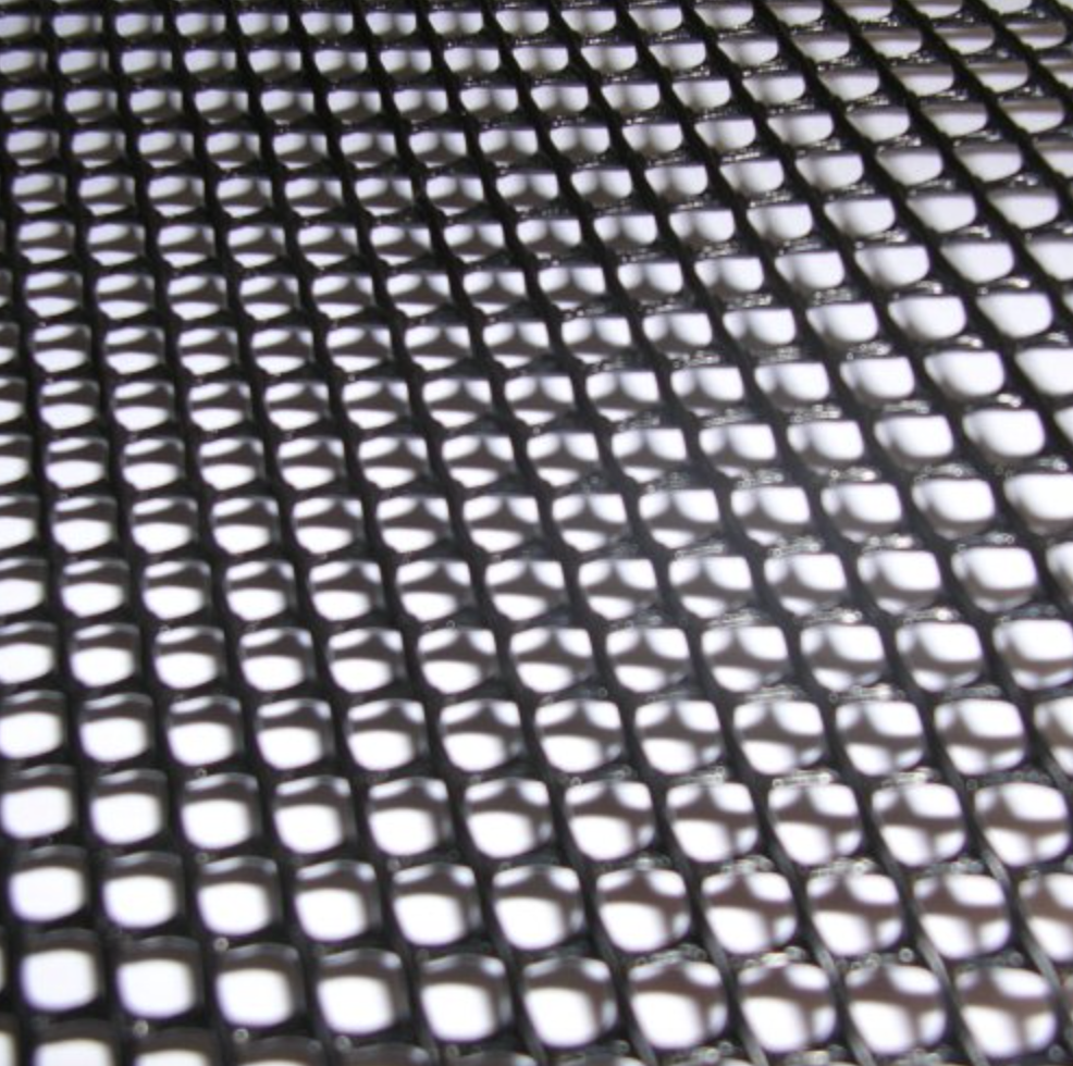 Close-up of a black mesh surface with evenly spaced square-shaped holes.
