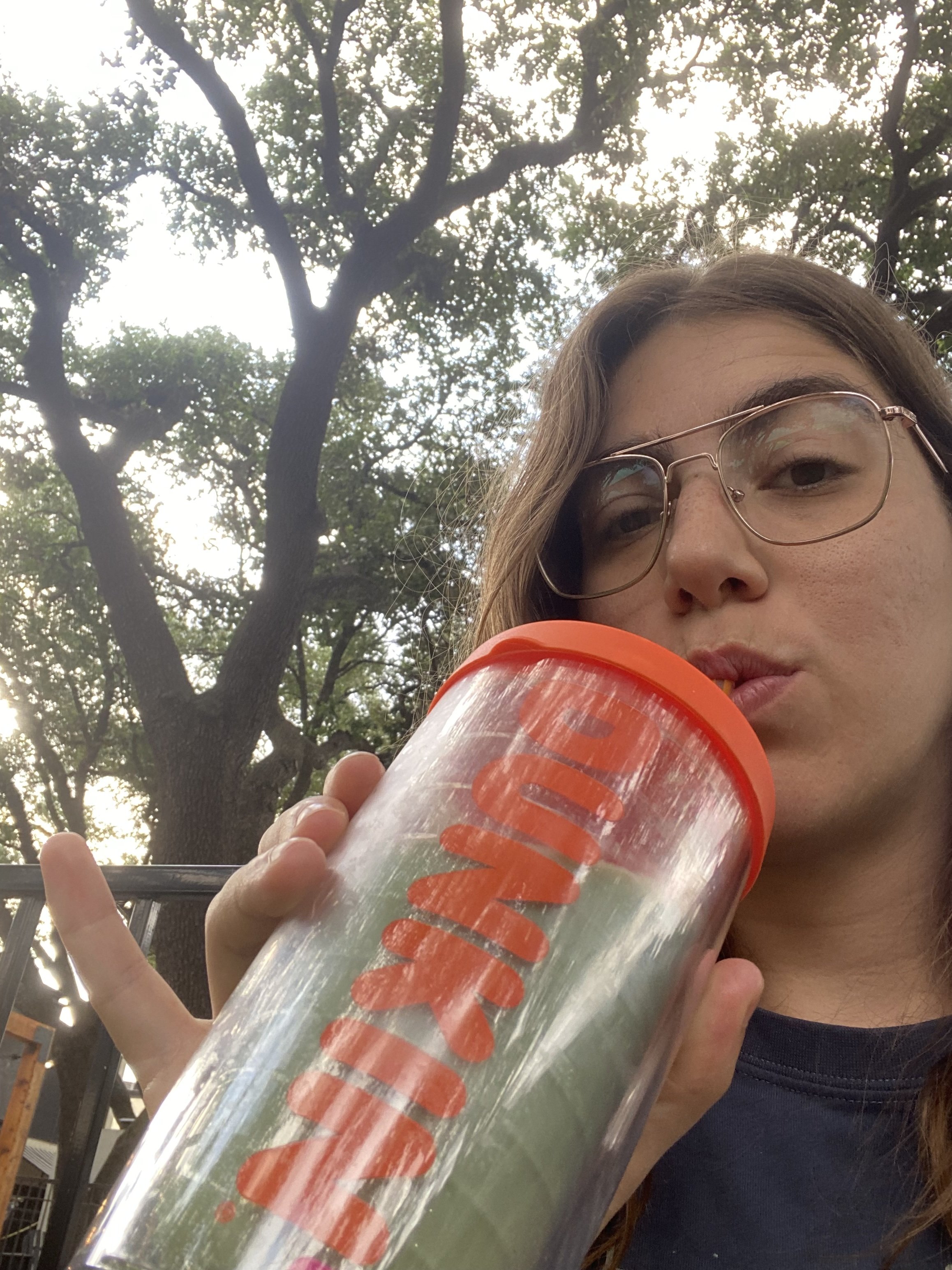 Unconventional therapist drinking matcha with pinky up