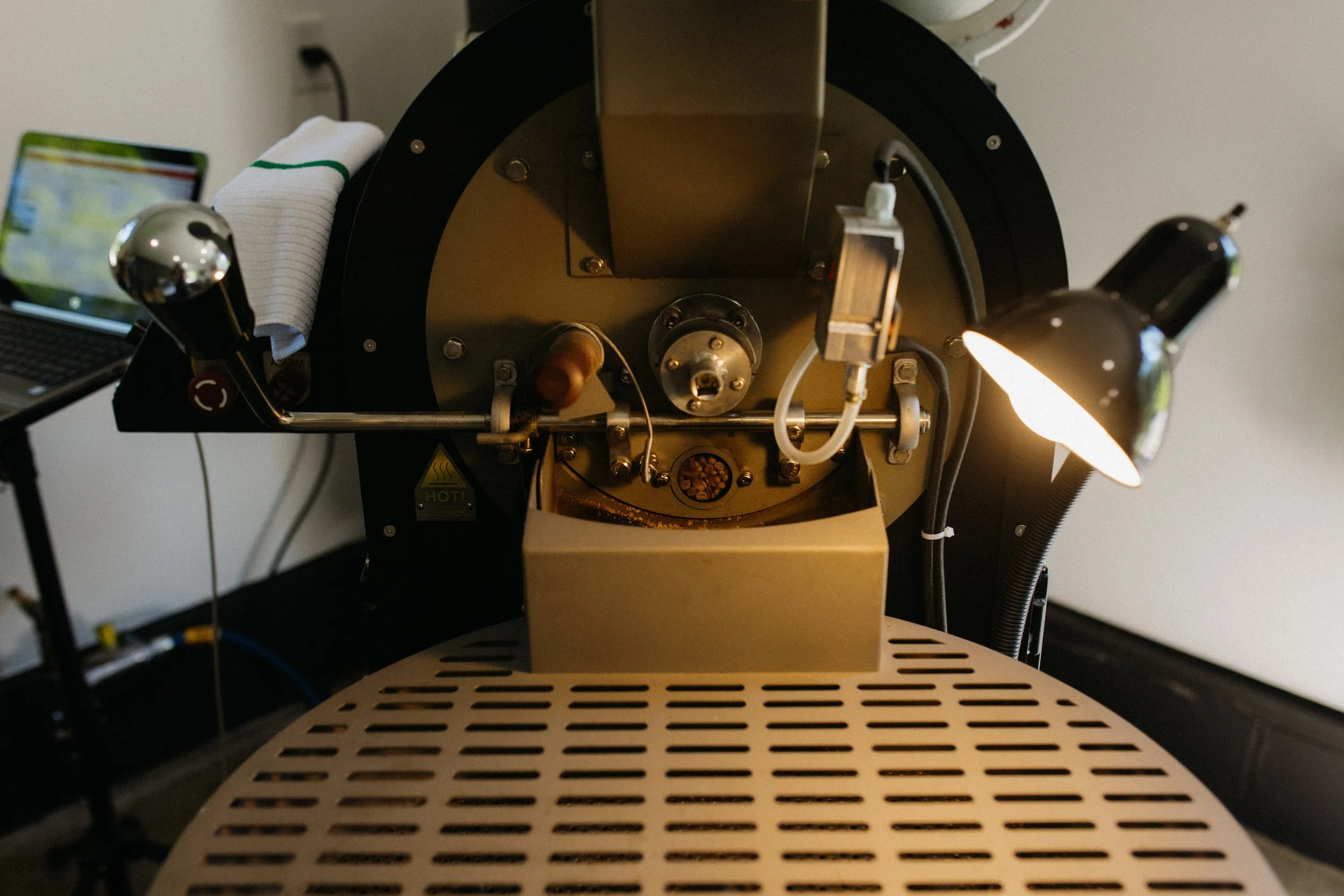Close-up view of scientific equipment with metallic components, wires, and lighting, possibly part of a laboratory or research apparatus.
