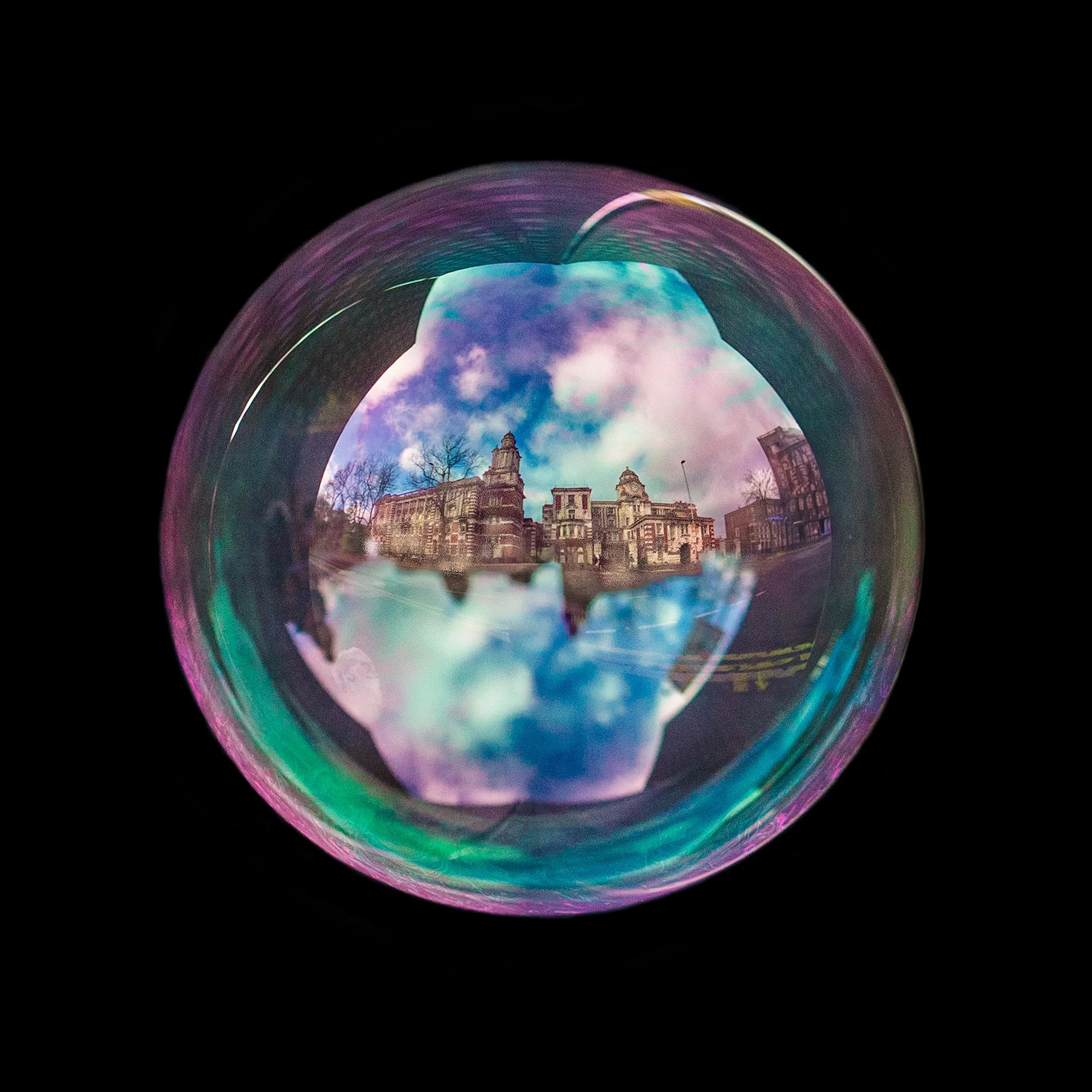 Fine art photograph of a real soap bubble reflecting Manchester royal infirmary hospital in the city centre