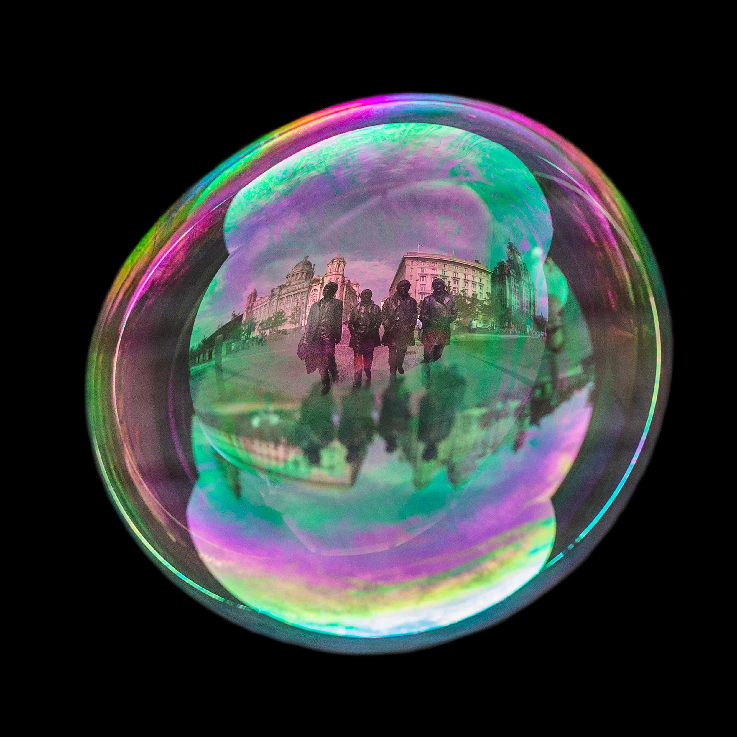 Fine art bubble photograph capturing beatles statue in liverpool inside a real soap bubble
