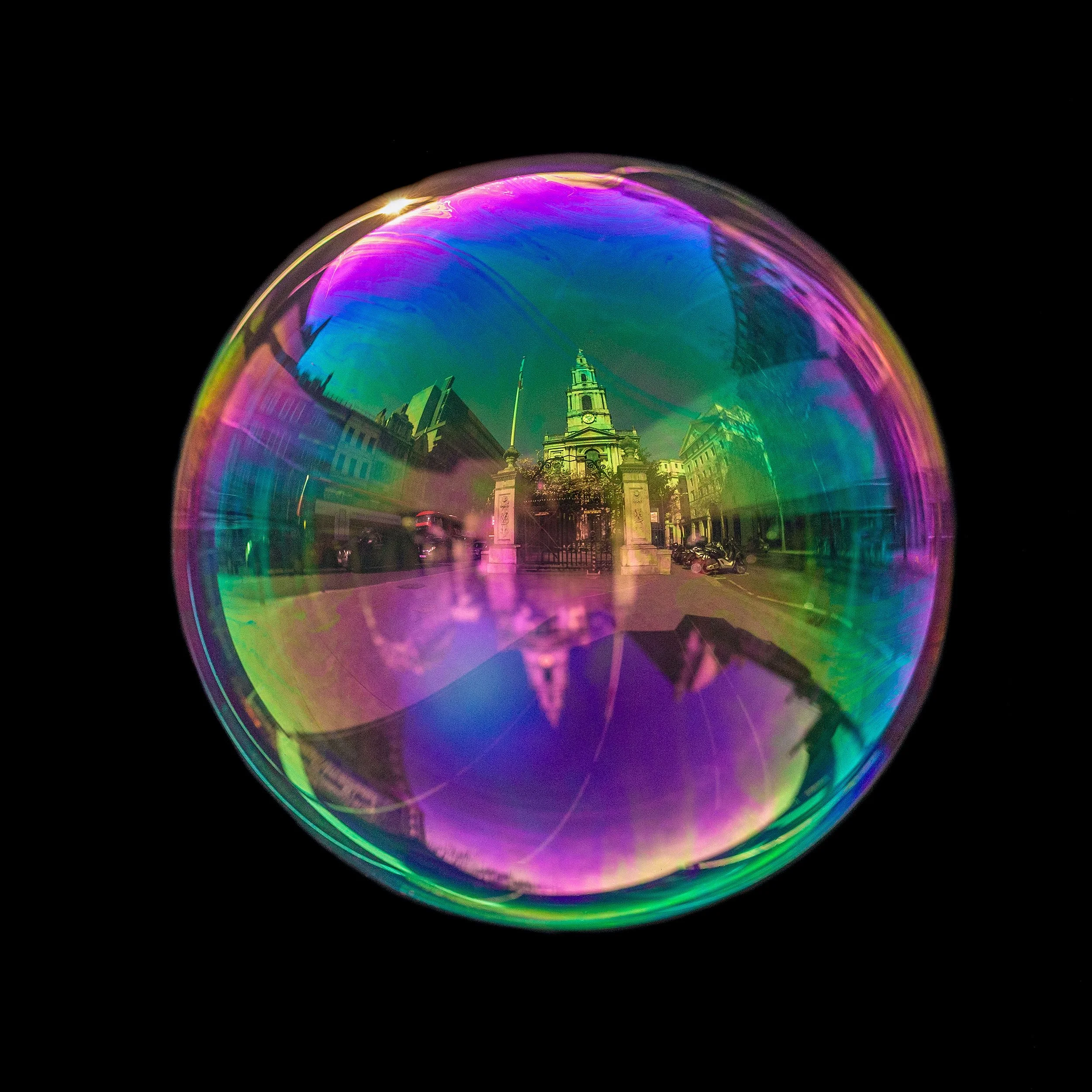 Fine art bubble photograph capturing Parish Church of St Mary-Le-Strand in London inside a real soap bubble