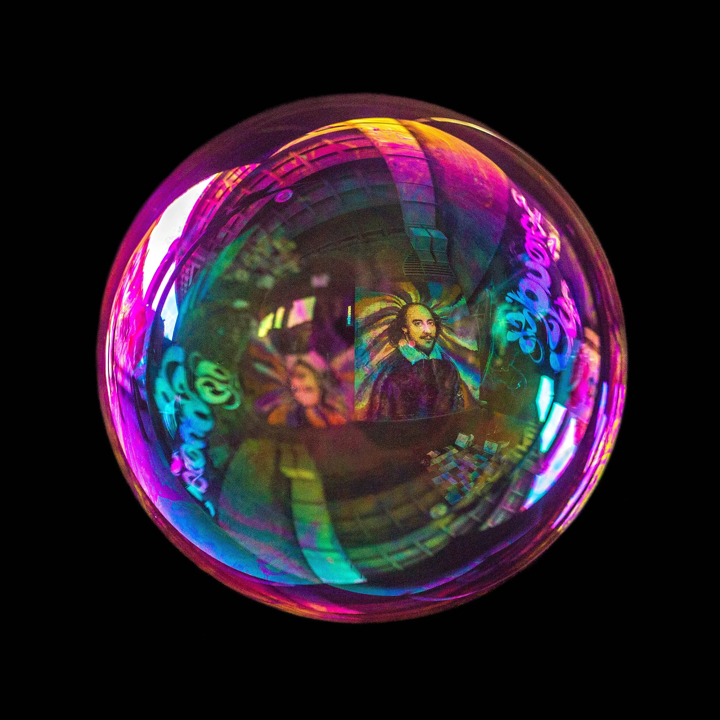 Fine art bubble photograph capturing shakespear portrait graffiti in london inside a real soap bubble
