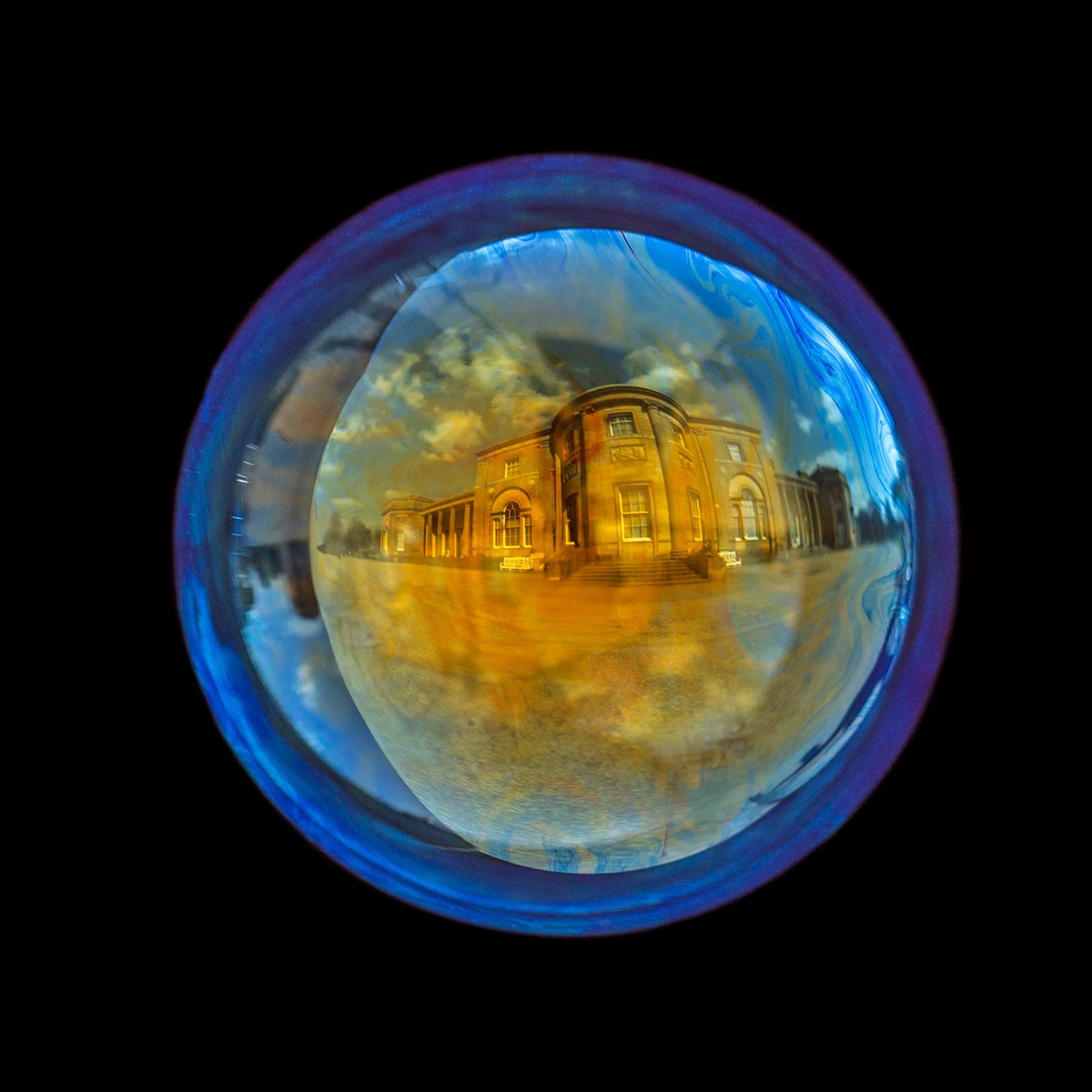 Fine art photograph of a real soap bubble reflecting heaton park building in Manchester