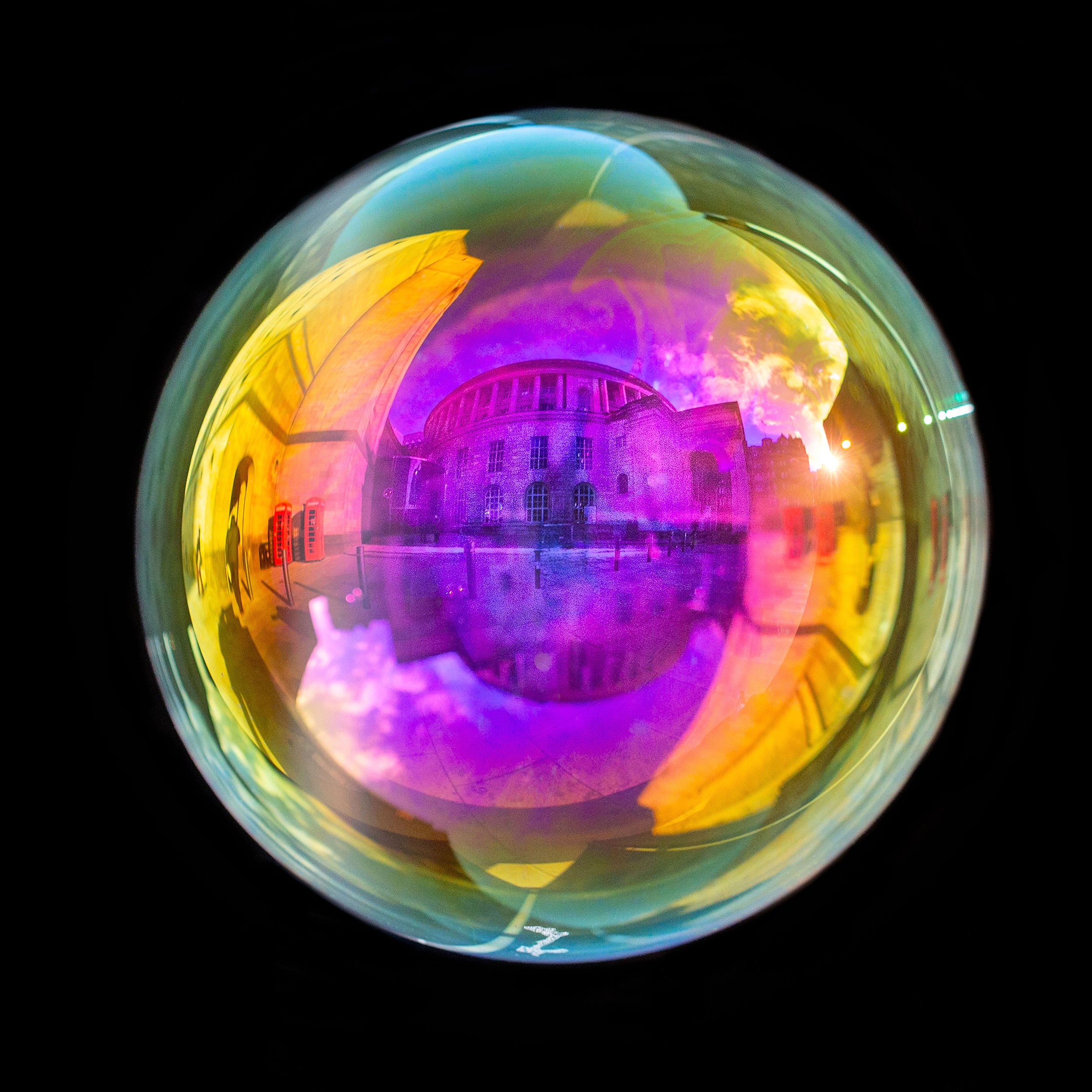 Fine art photograph of a real soap bubble reflecting Manchester central library in the city centre