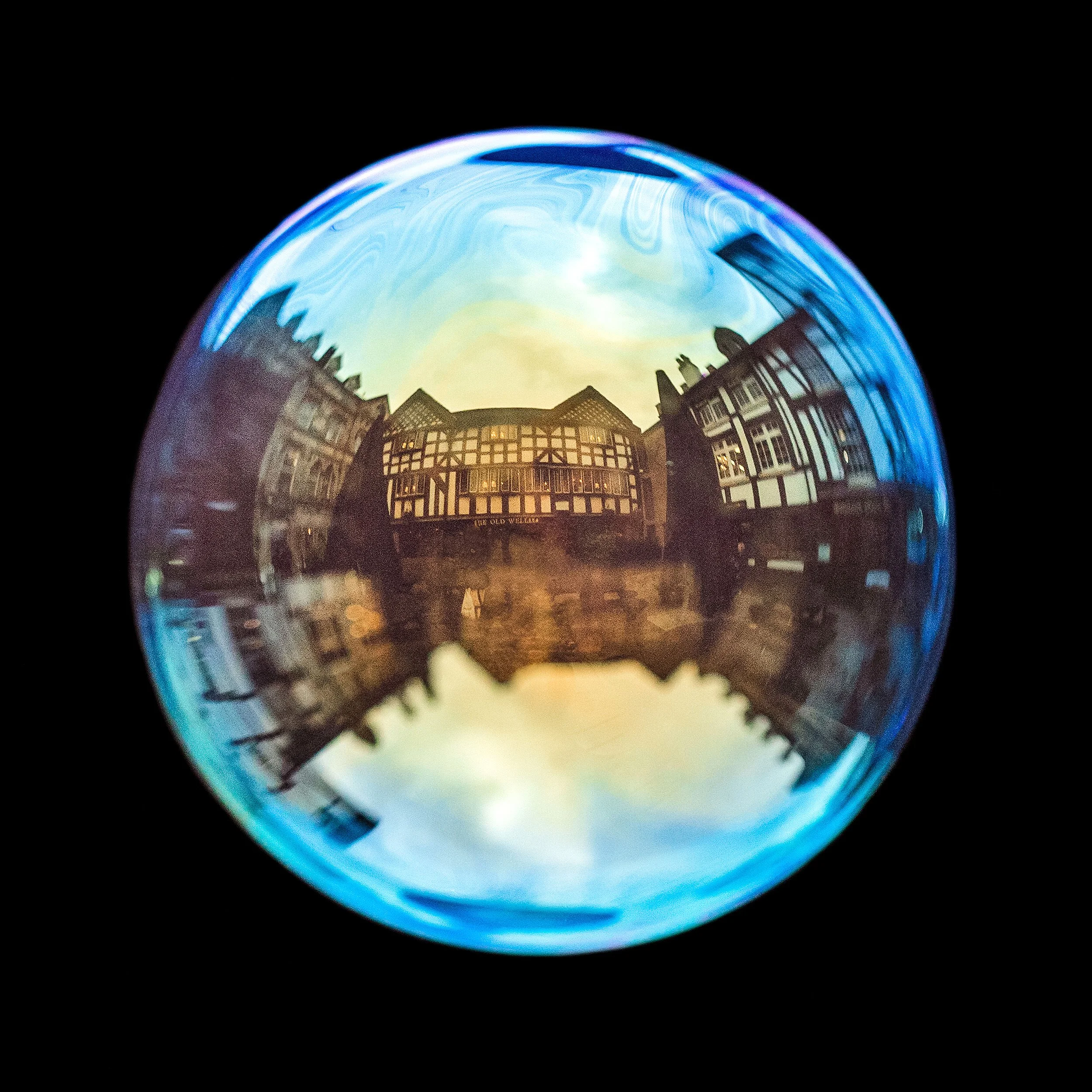Fine art photograph of a real soap bubble reflecting shambles in Manchester city centre