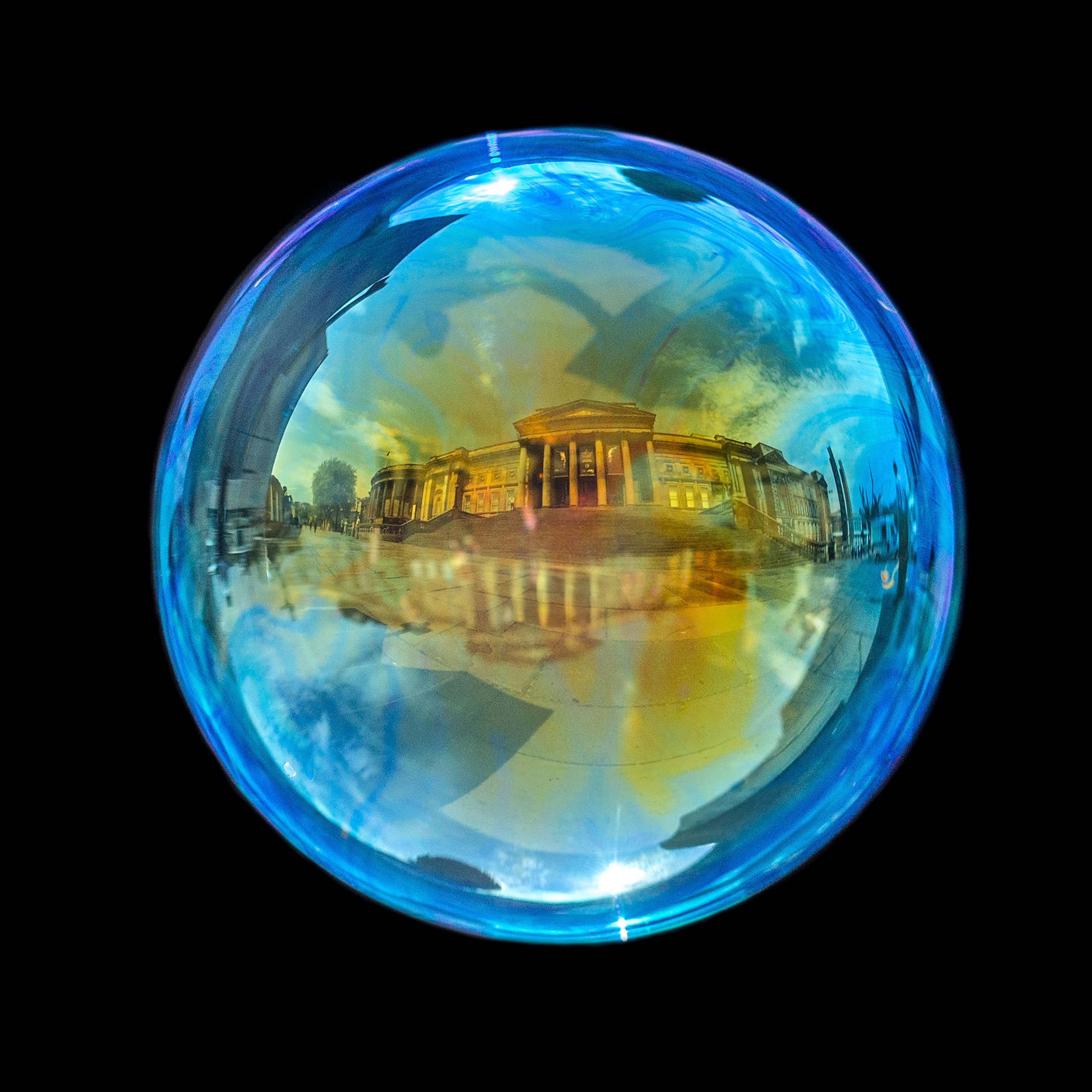 Fine art bubble photograph capturing st george's hall in liverpool inside a real soap bubble