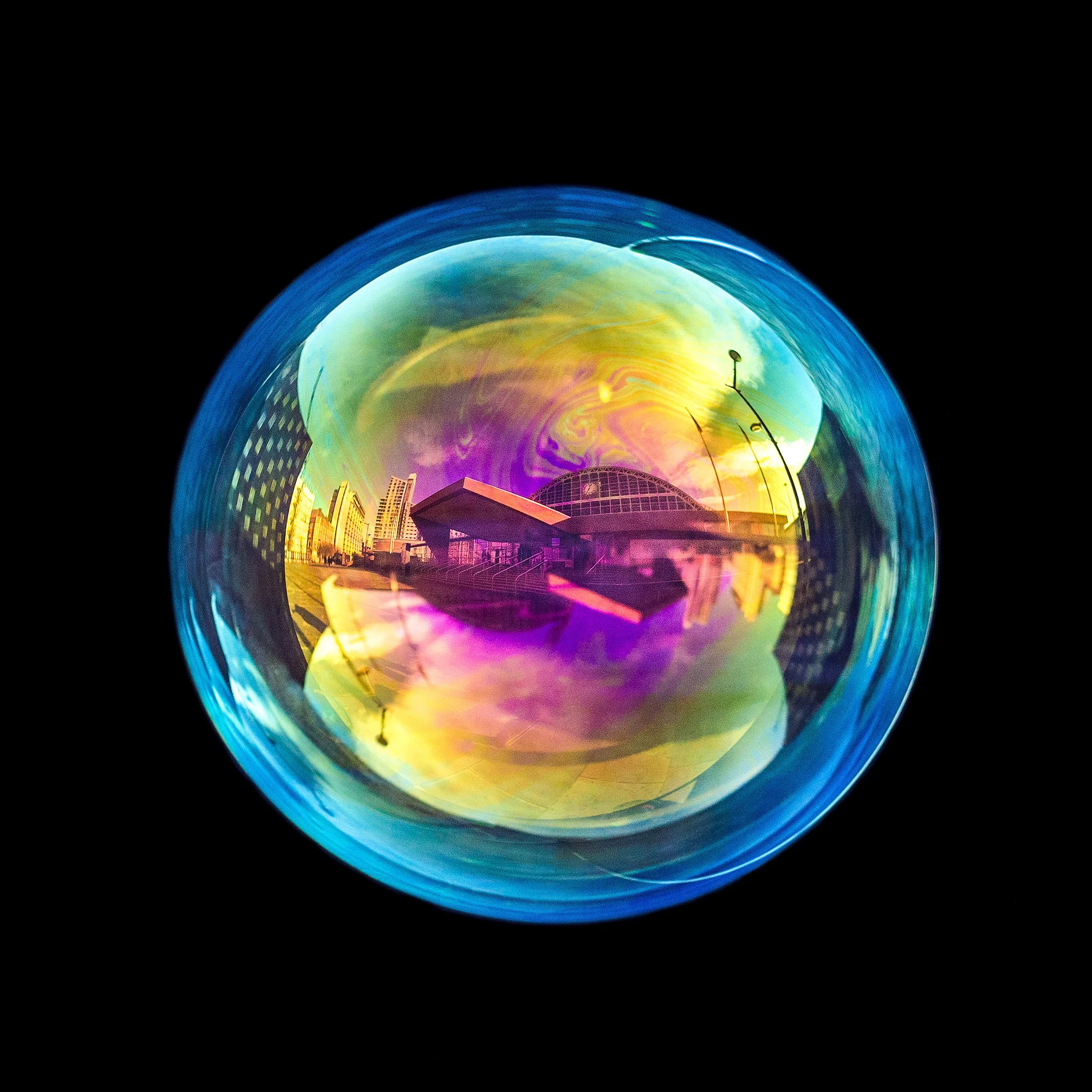 Fine art photograph of a real soap bubble reflecting Manchester central convention center gmex in the city centre