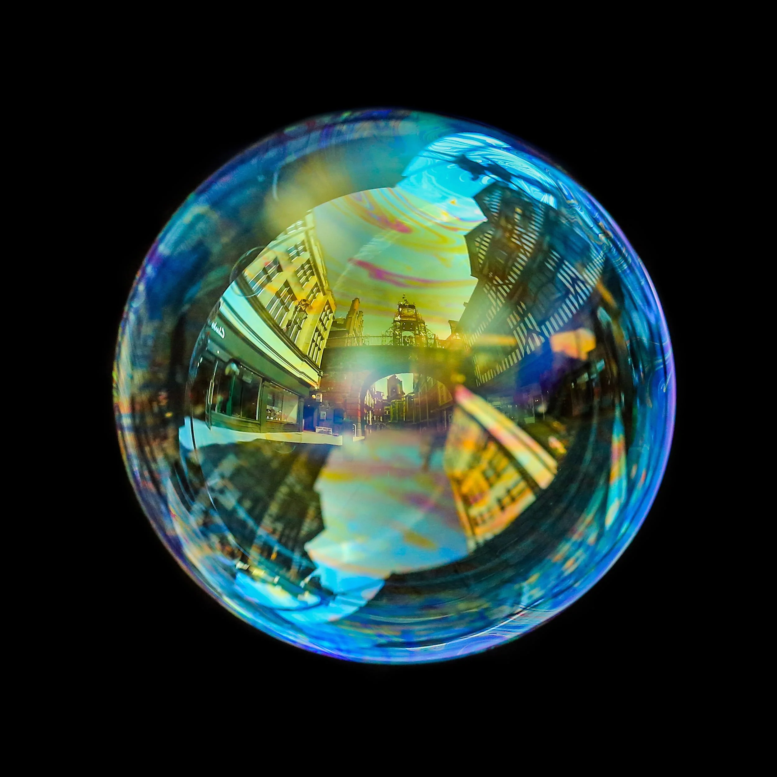 Fine art bubble photograph capturing Chester eastgate archway inside a real soap bubble