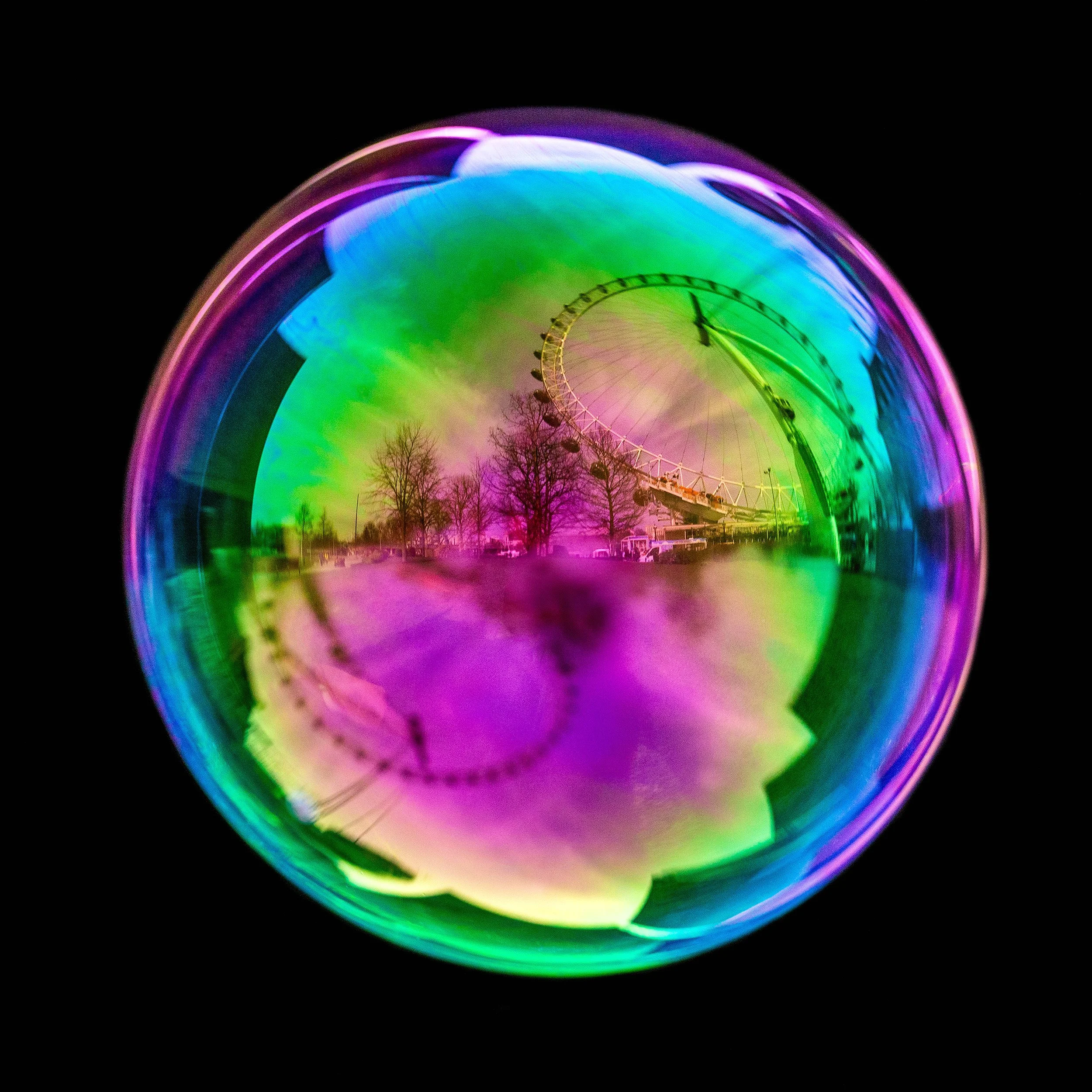 Real soap bubble photography featuring London eye wheel and urban reflections