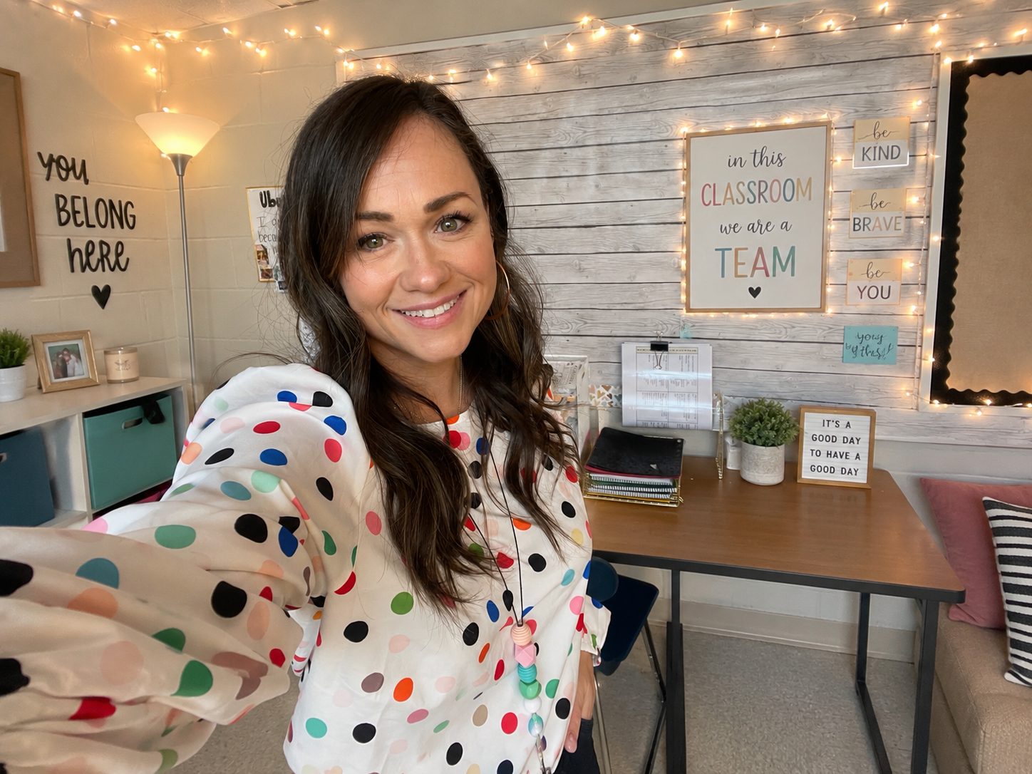 Instructional coach and educator Shel smiling in a bright, welcoming classroom.