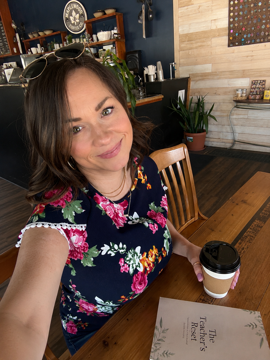 Shel enjoying coffee while writing stories and creating resources for educators and personal growth.