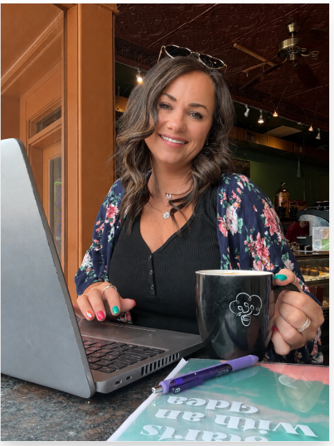 Shel working on personal growth content and teacher resources from a coffee shop.