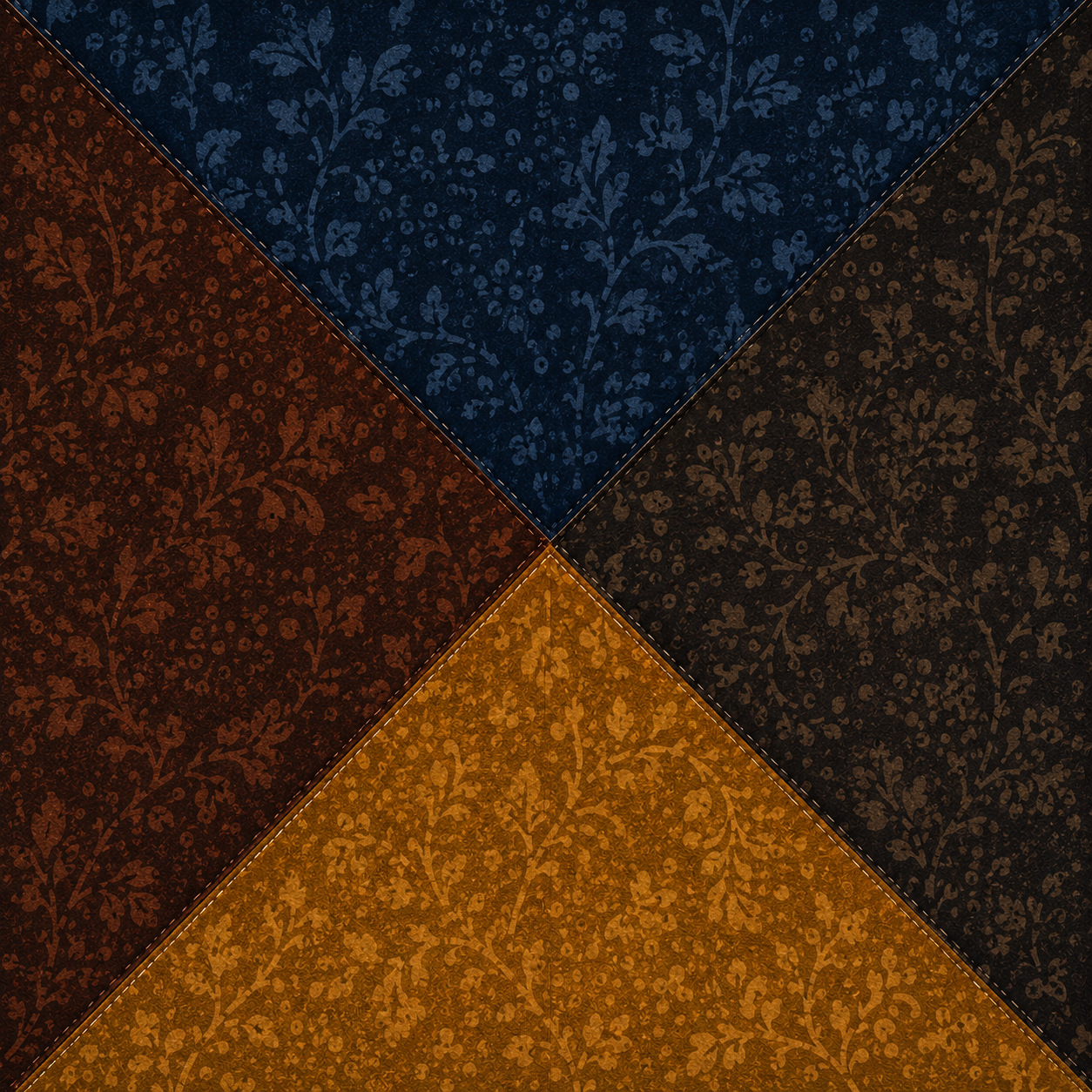 Close-up of four batik fabric pieces with floral patterns in blue, black, brown, and gold, stitched together diagonally.