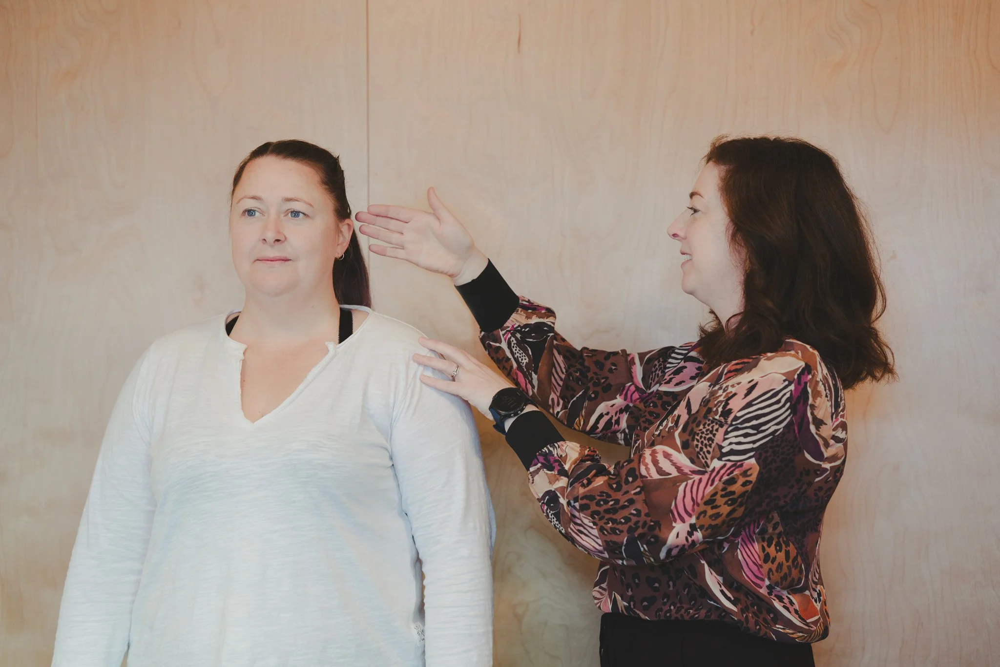 Physiotherapist Marianne Carroll performing postural analysis on a woman during an Align and Uplift consultation in Southland New Zealand