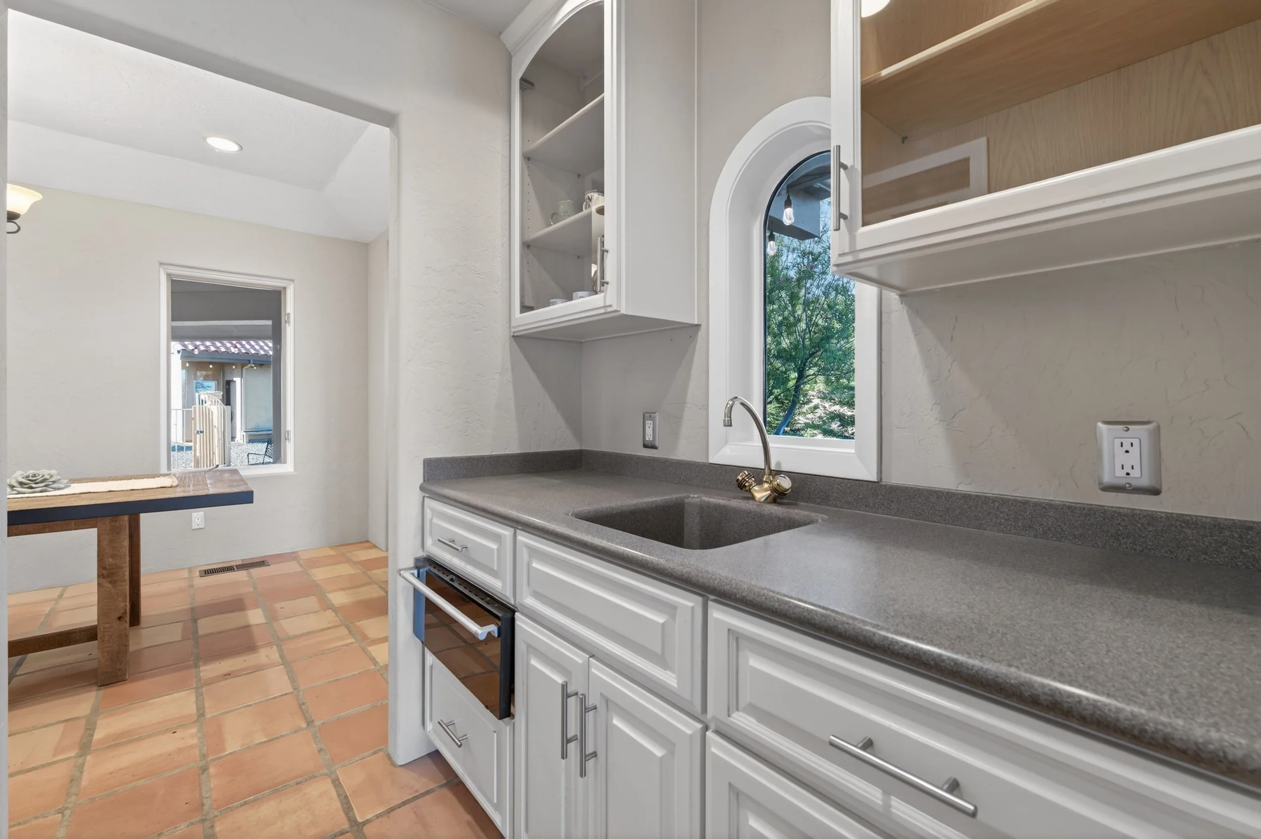 Butler's Pantry at Airola Ranch in Vallecito California featuring granite countertops, custom cabinetry, and indoor-outdoor living with scenic Sierra Foothill views