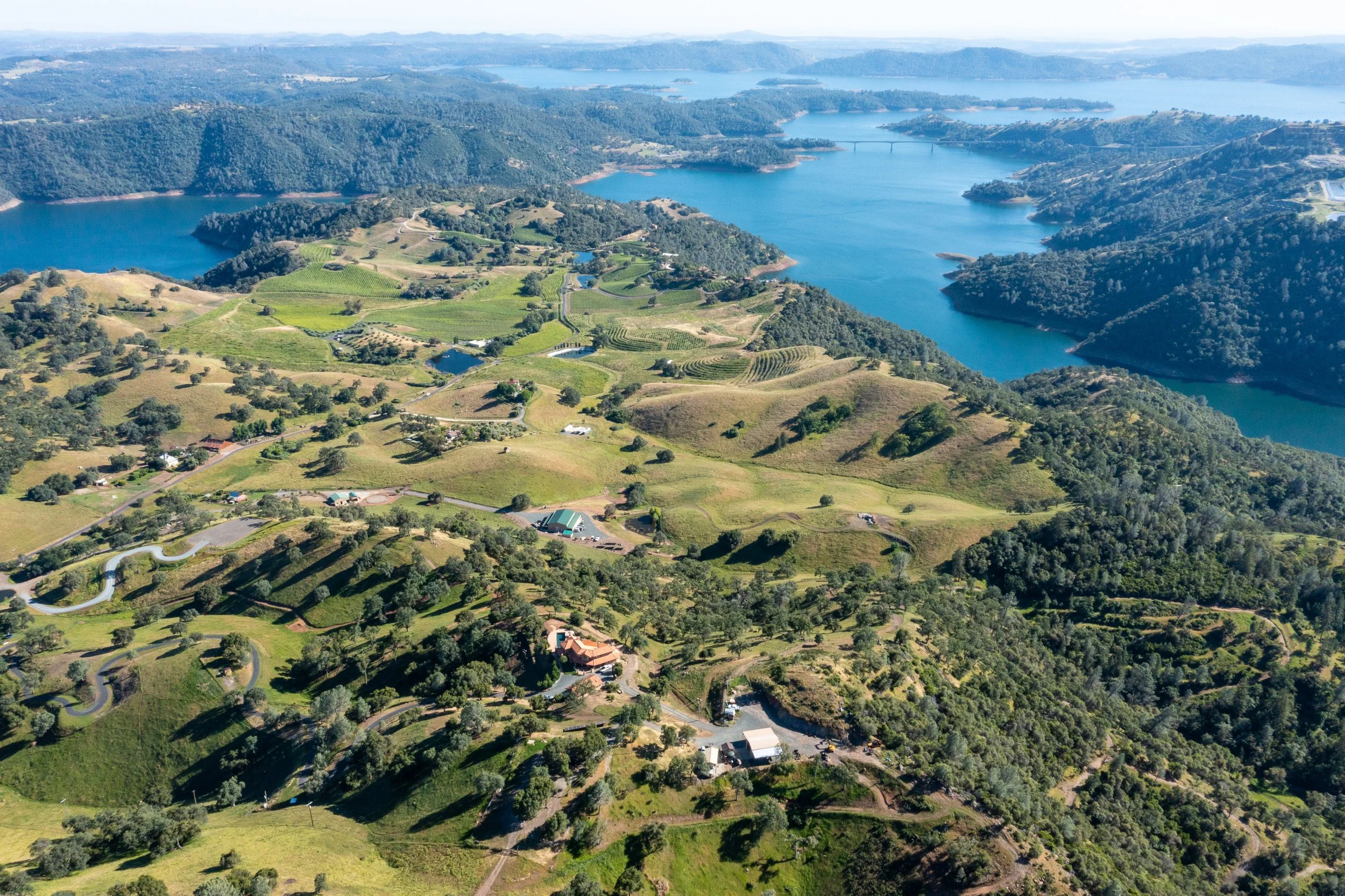 Scenic aerial landscape near Murphys and Angels Camp featuring rolling green hills, lakes, and California Gold Country beauty.