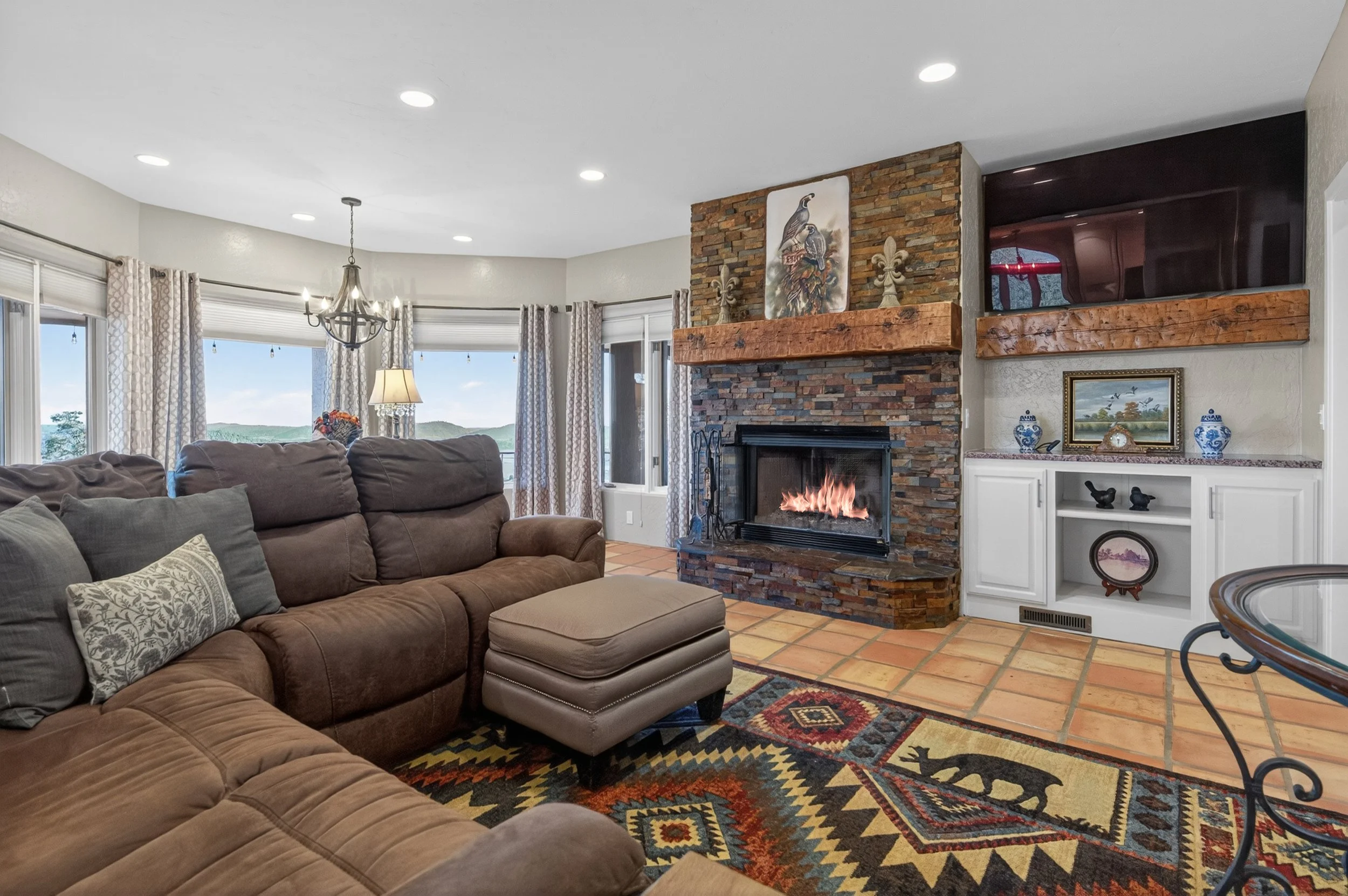 Elegant living space at Airola Ranch with natural stone fireplace, custom finishes, and refined California foothill ambiance