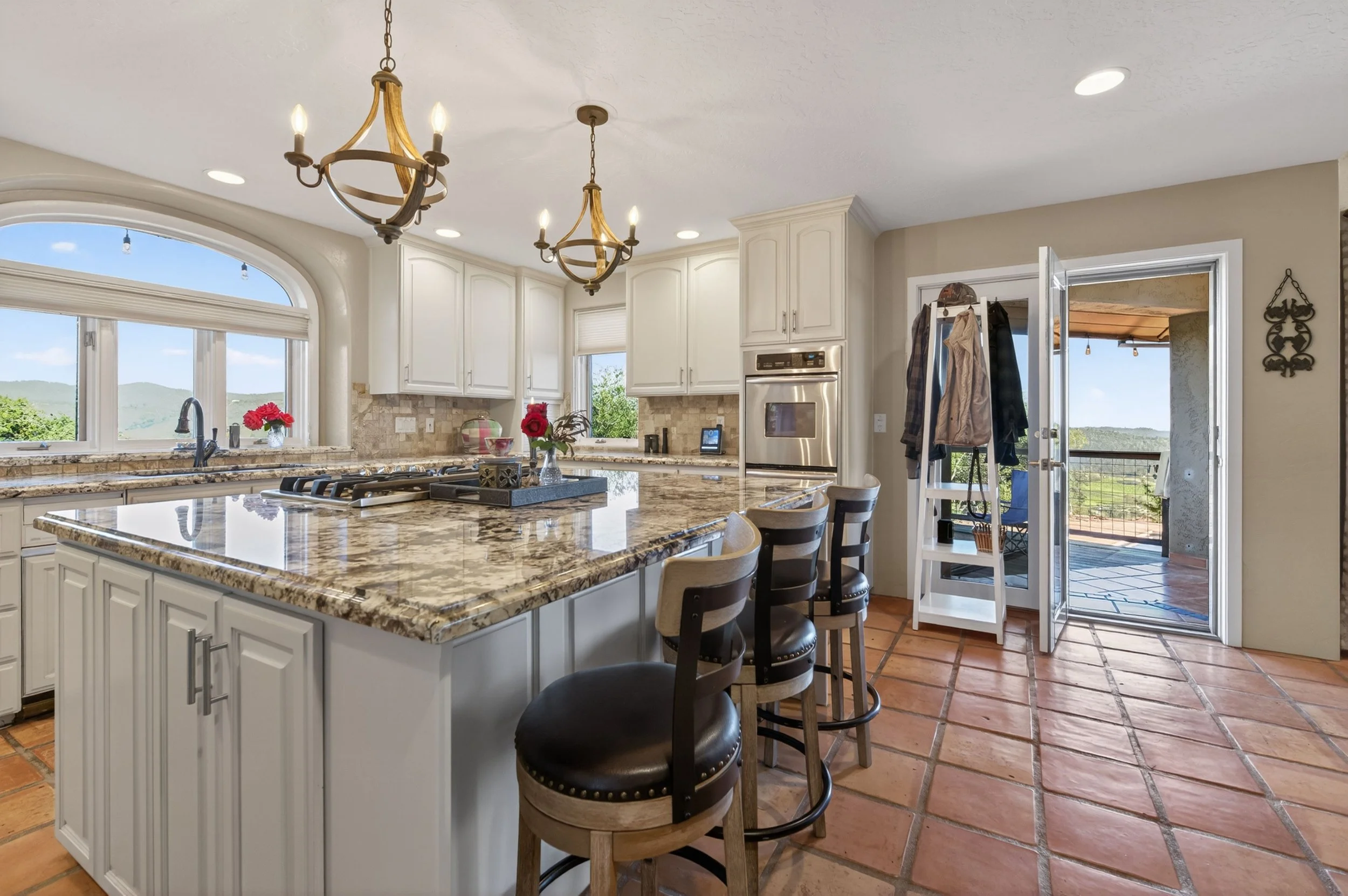 Chef’s kitchen with granite countertops and views of New Melones Lake at Airola Road property